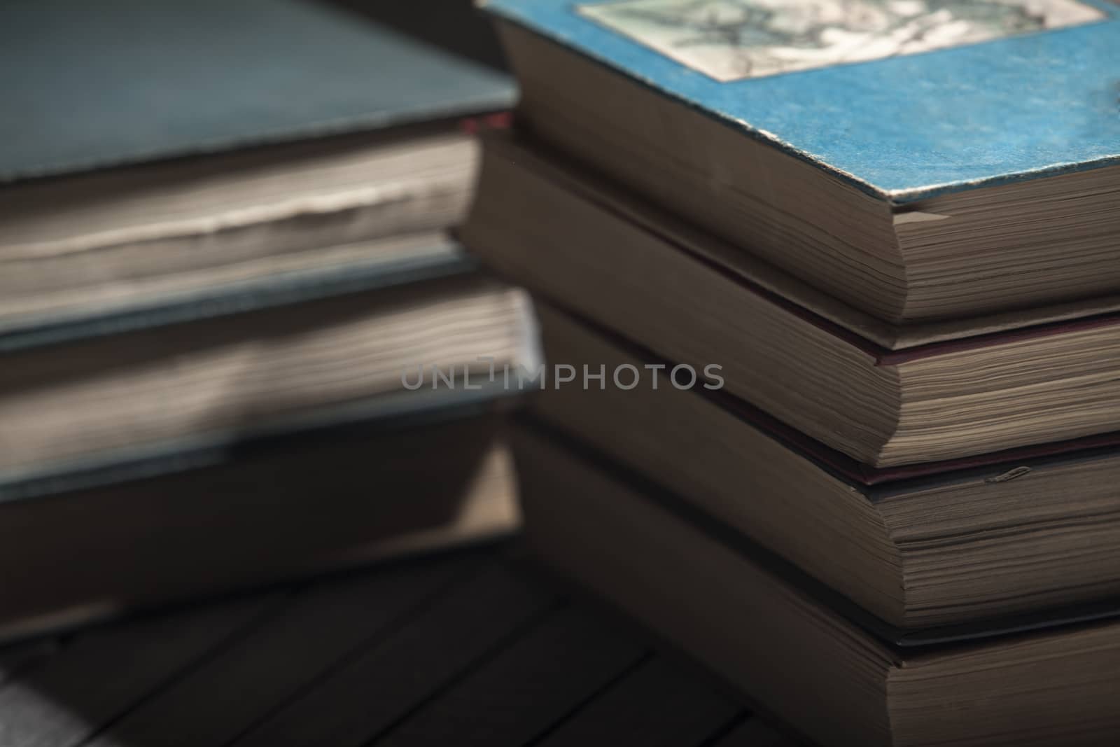 The pile of books lies on a table, a background, other pile, knowledge, library