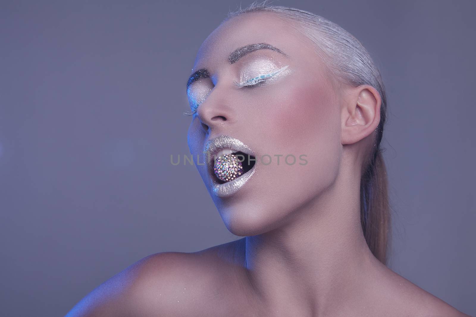 Studio beauty portrait of a beautiful girl with a makeup of snow queen