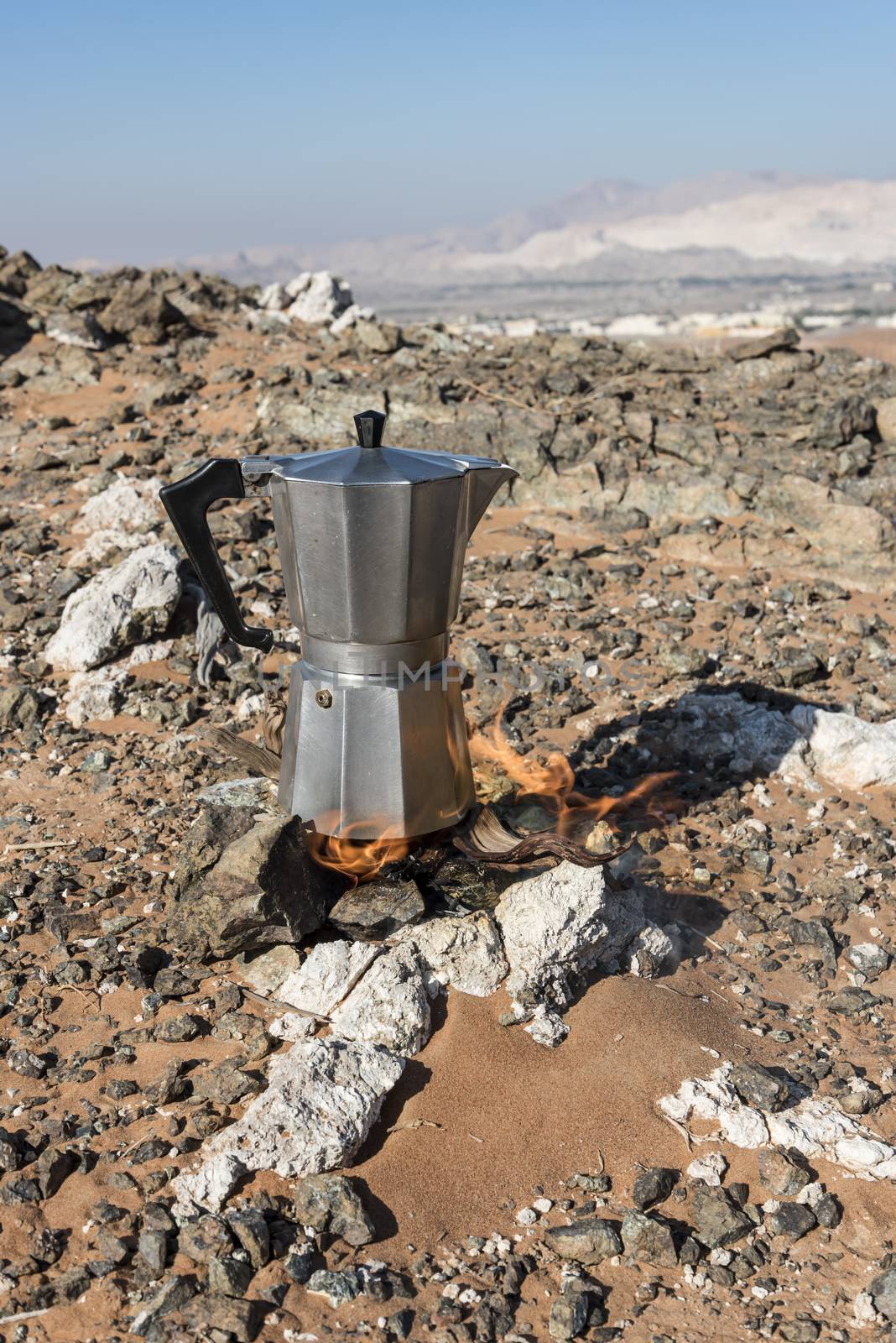 Italian Coffee maker at a fireplace in the desert by GABIS