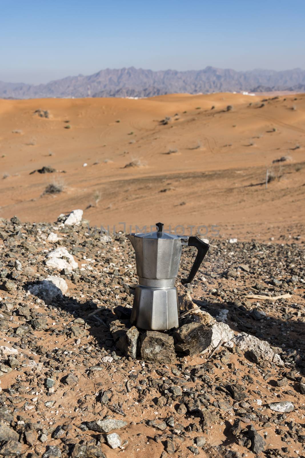 Italian Coffee maker at a fireplace in the desert by GABIS