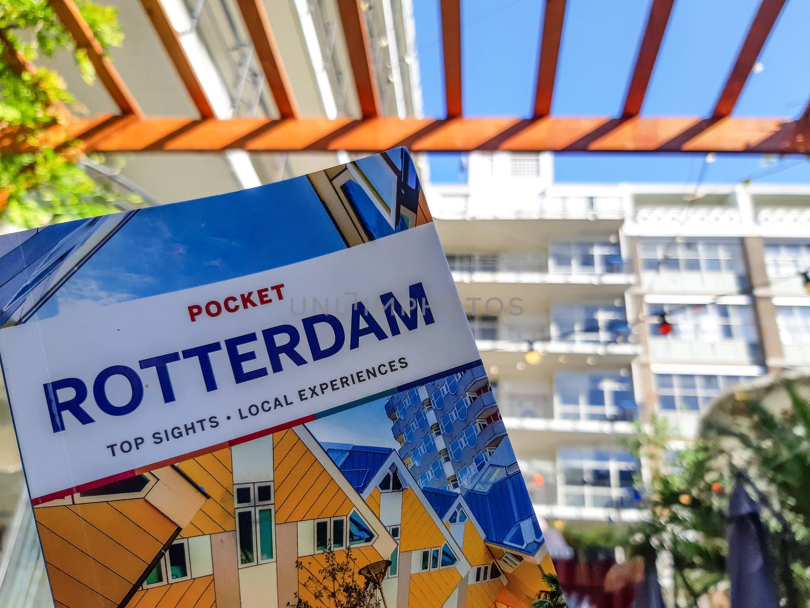 Lonely Planet travel guide book of Rotterdam with architecture in the background. Travel and Tourism in the Netherlands. Illustrative Editorial.