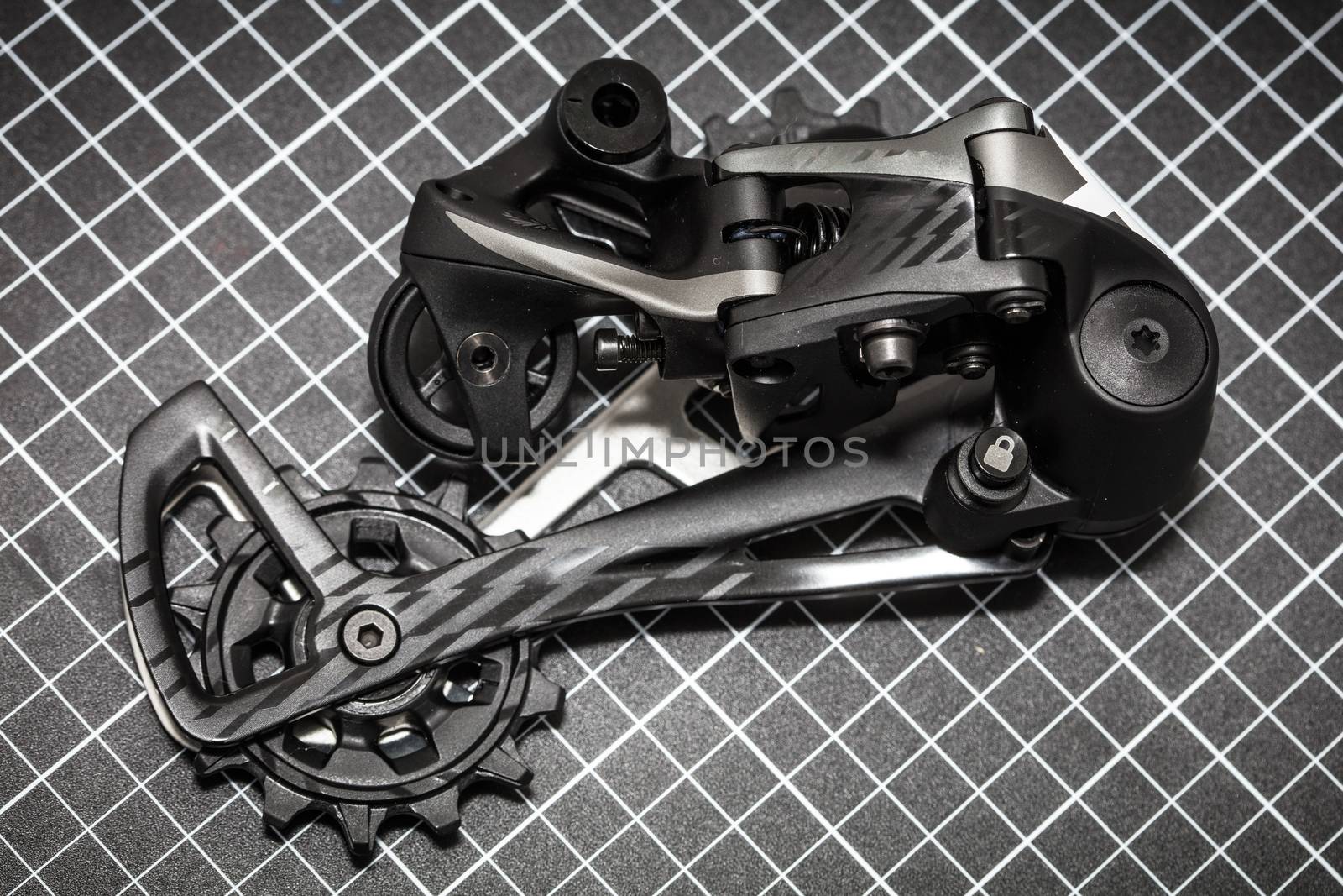 A bicycle rear derailleur ready to be installed onto a mountain bike