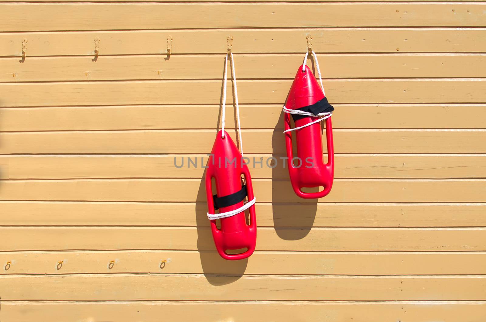 Two red rescue buoys. by KajaNi