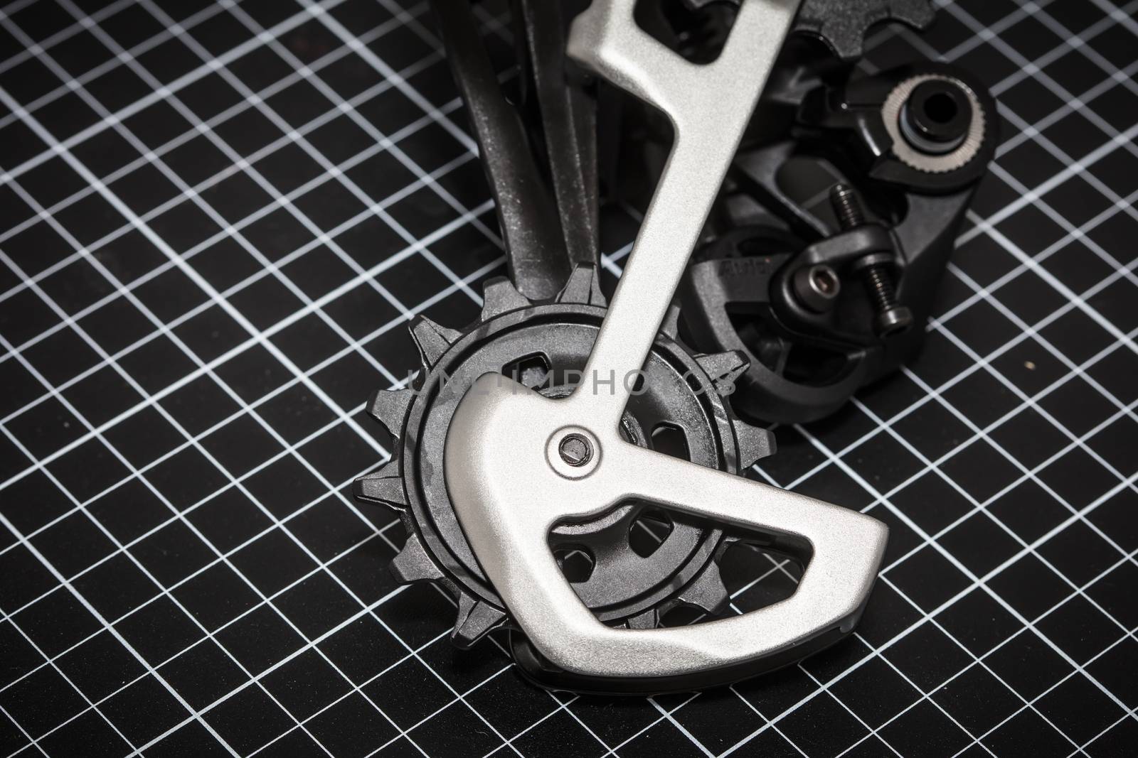 A bicycle rear derailleur ready to be installed onto a mountain bike