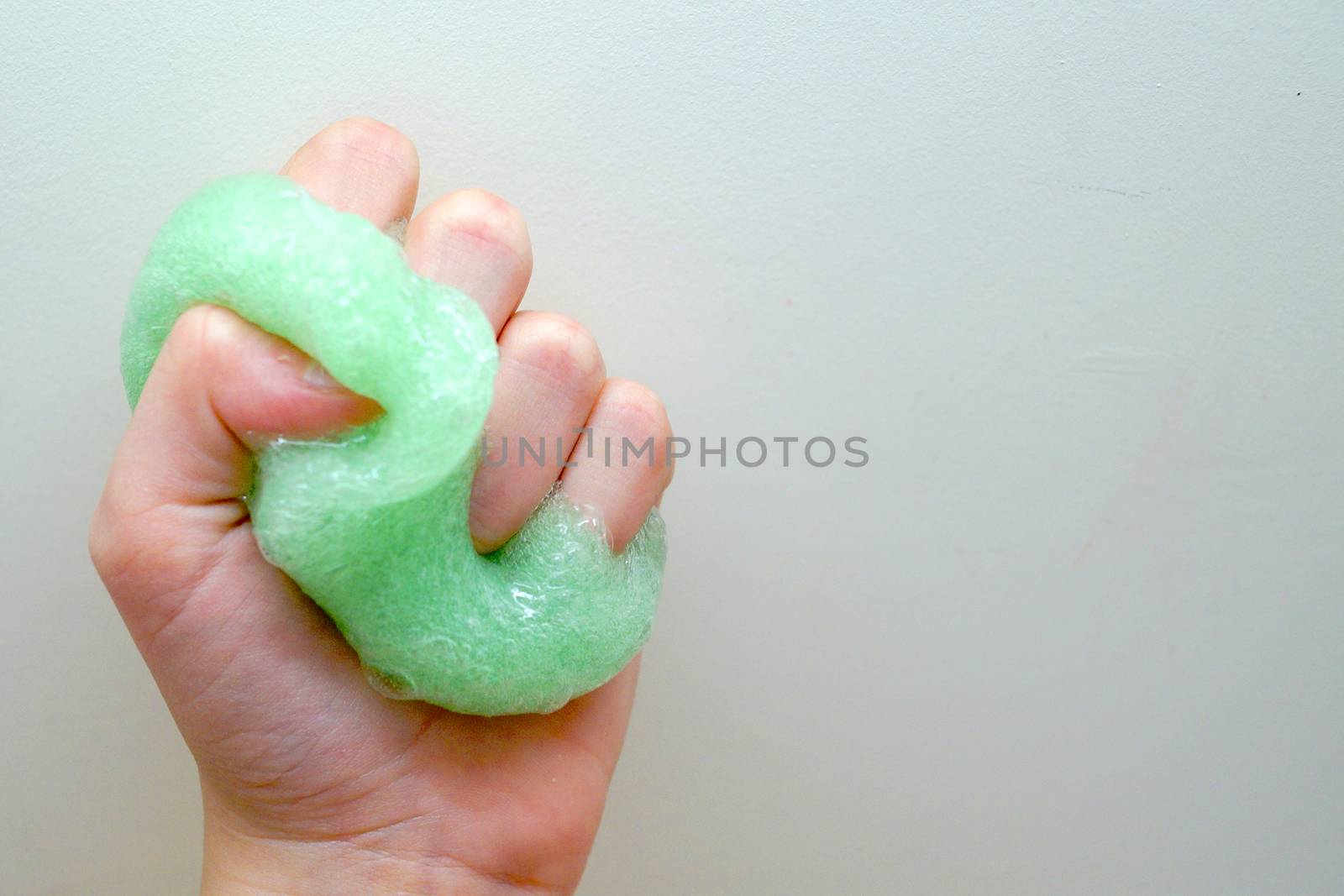 green slime in a child's hand close up