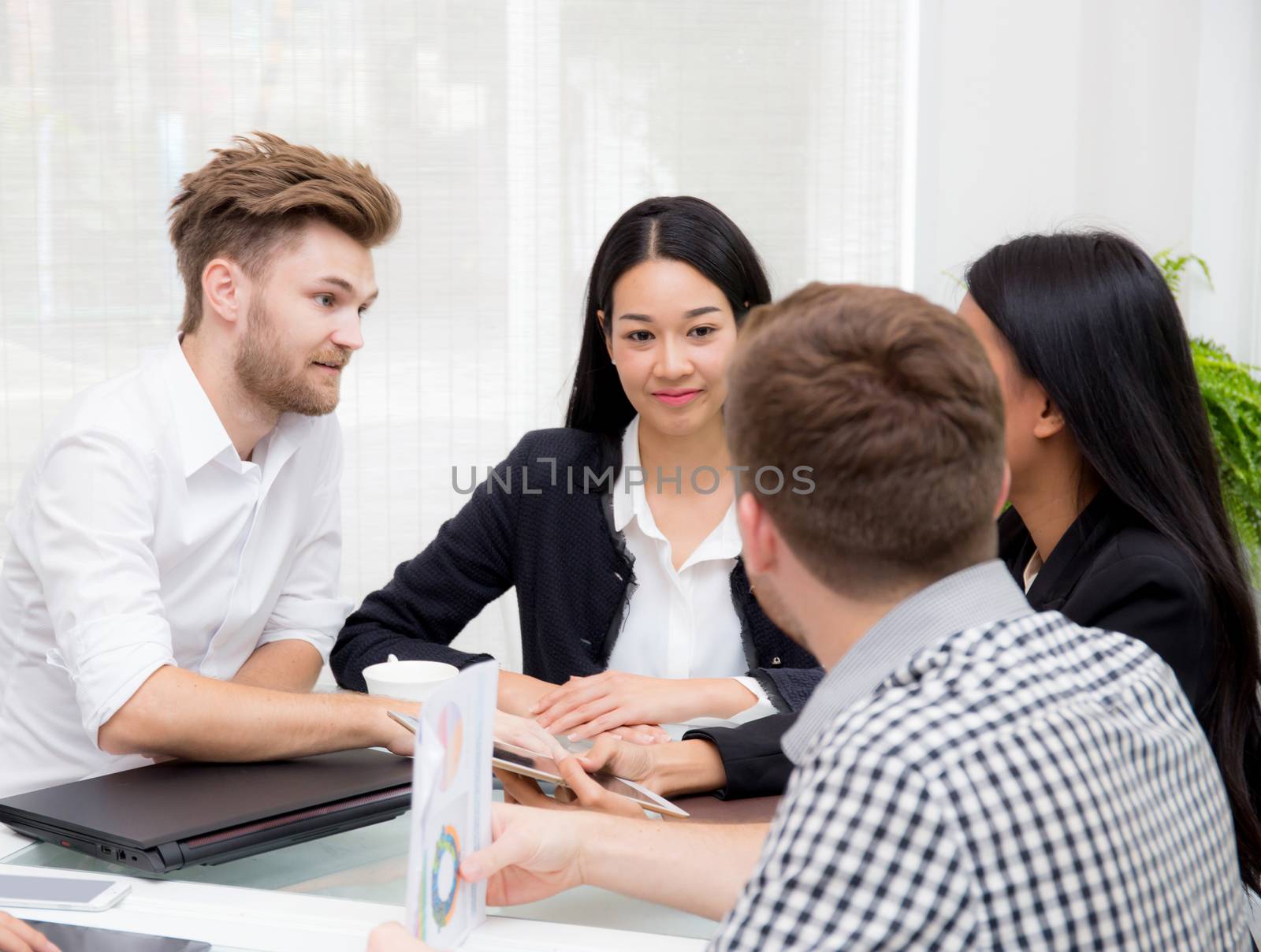 Group of business people brainstorming together in the meeting room.