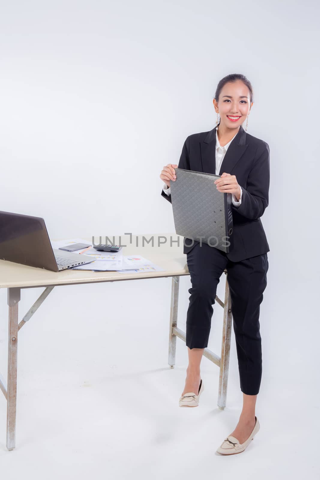 businesswoman hold file document looking camera with sitting table in office on white background.