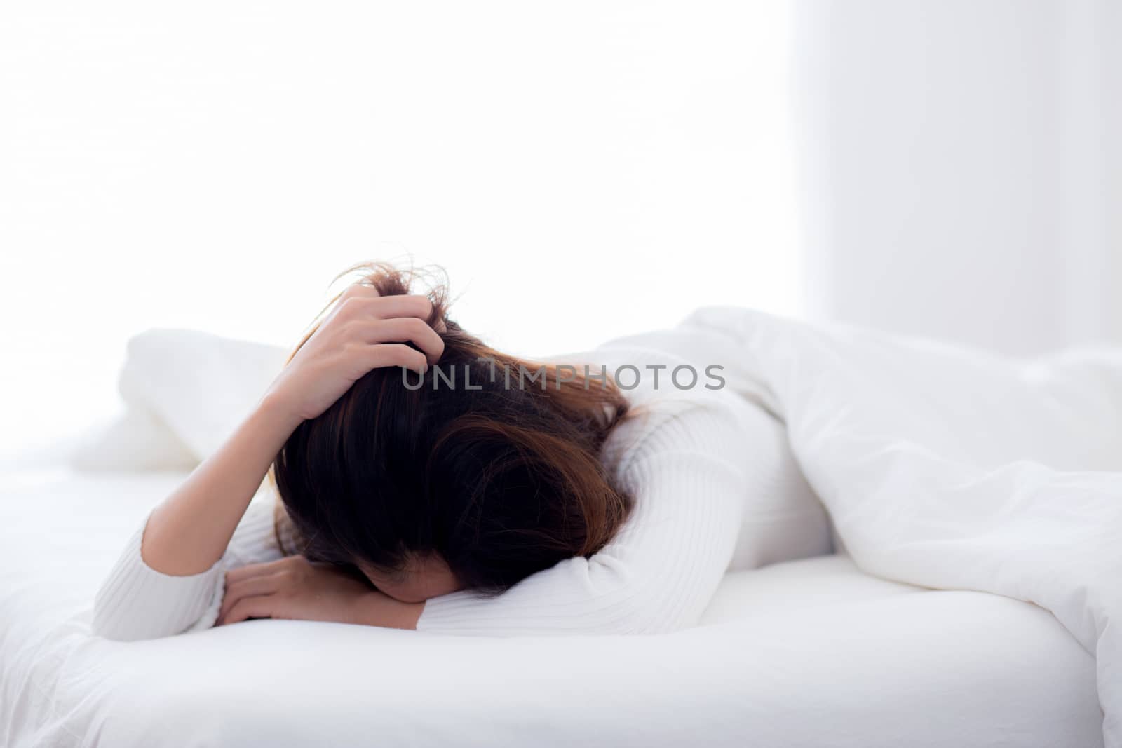 girl with tired for work on bed sleeping at home in the bedroom - woman want leisure for healthcare concept.