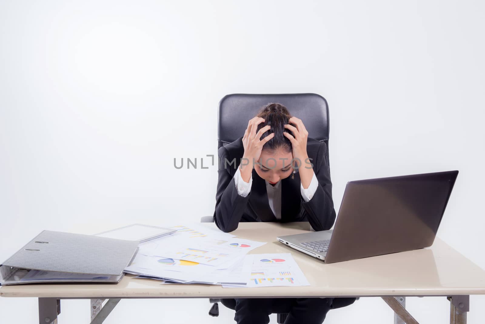 working woman are stressed from pile of work  in front of her in work concept - asian woman stressful job concept.