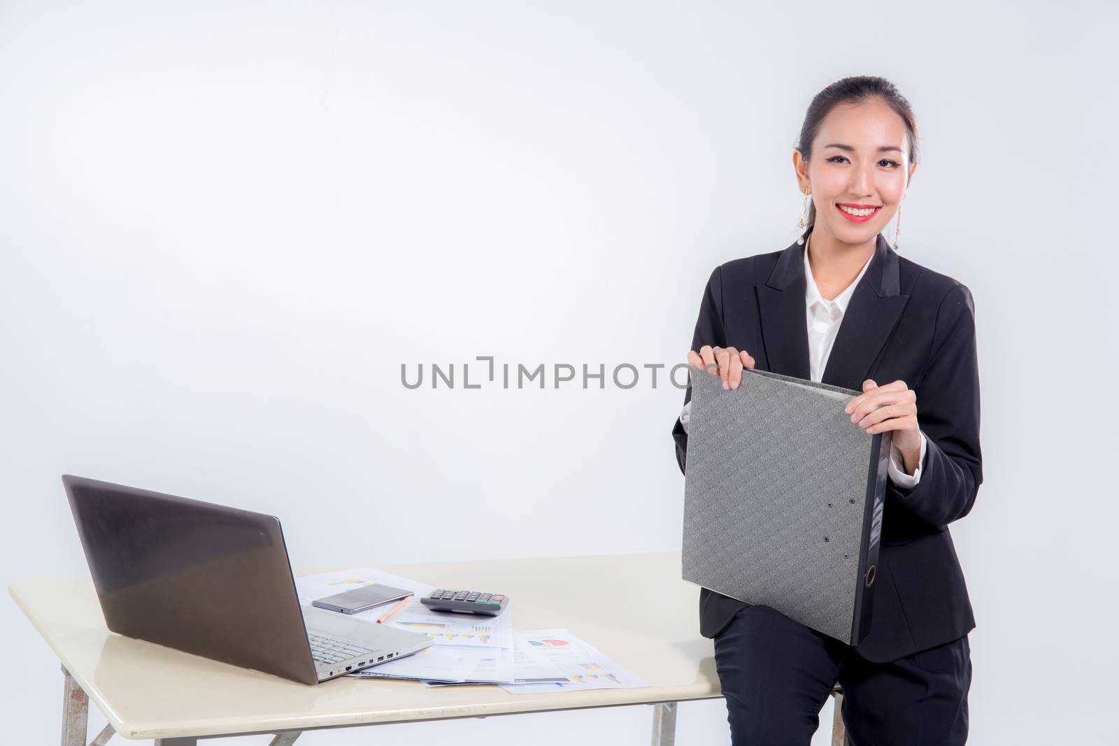 businesswoman hold file document looking camera with sitting table in office on white background.