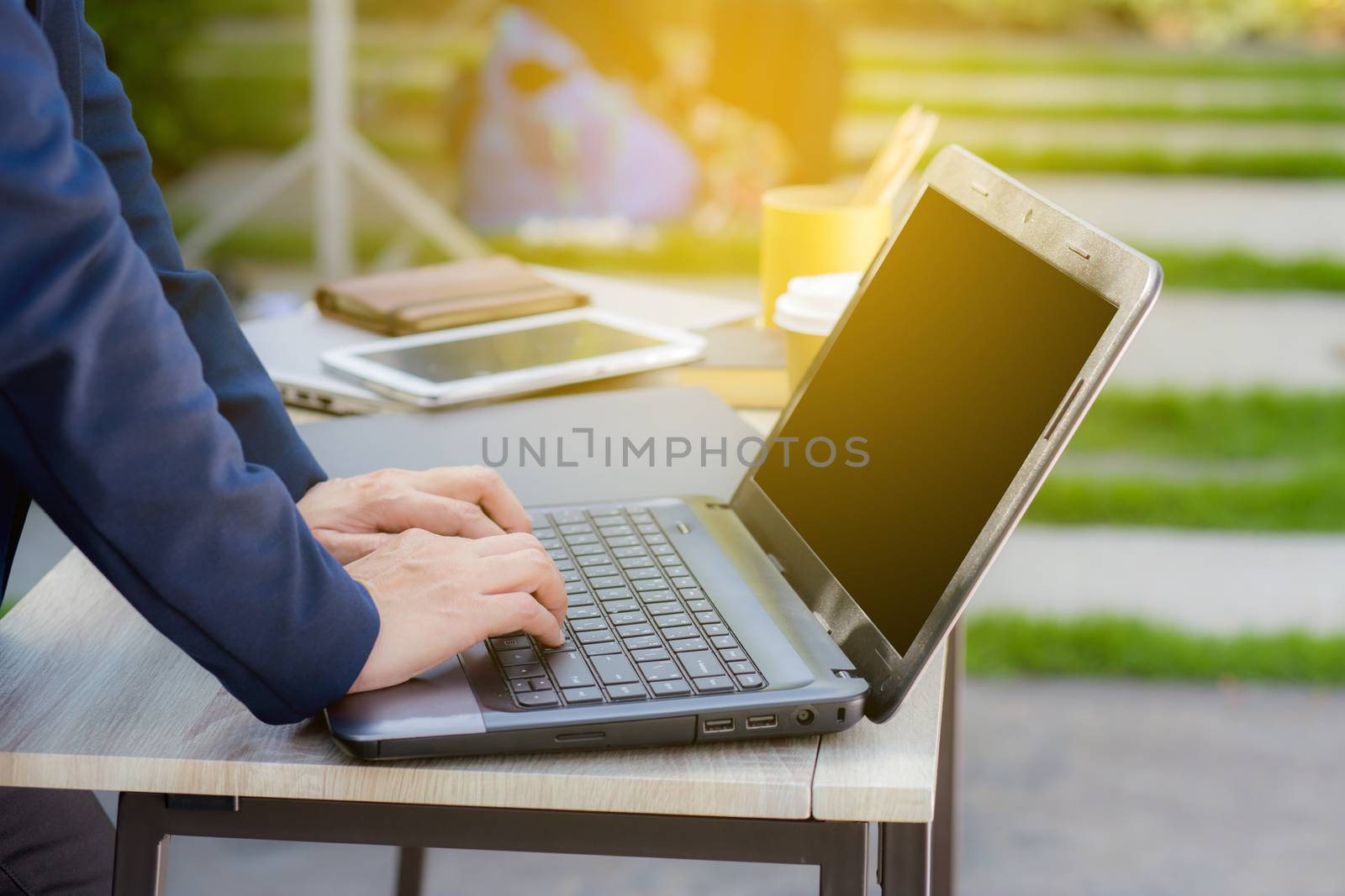 Closeup image of a hands working and typing on laptop keyboard.