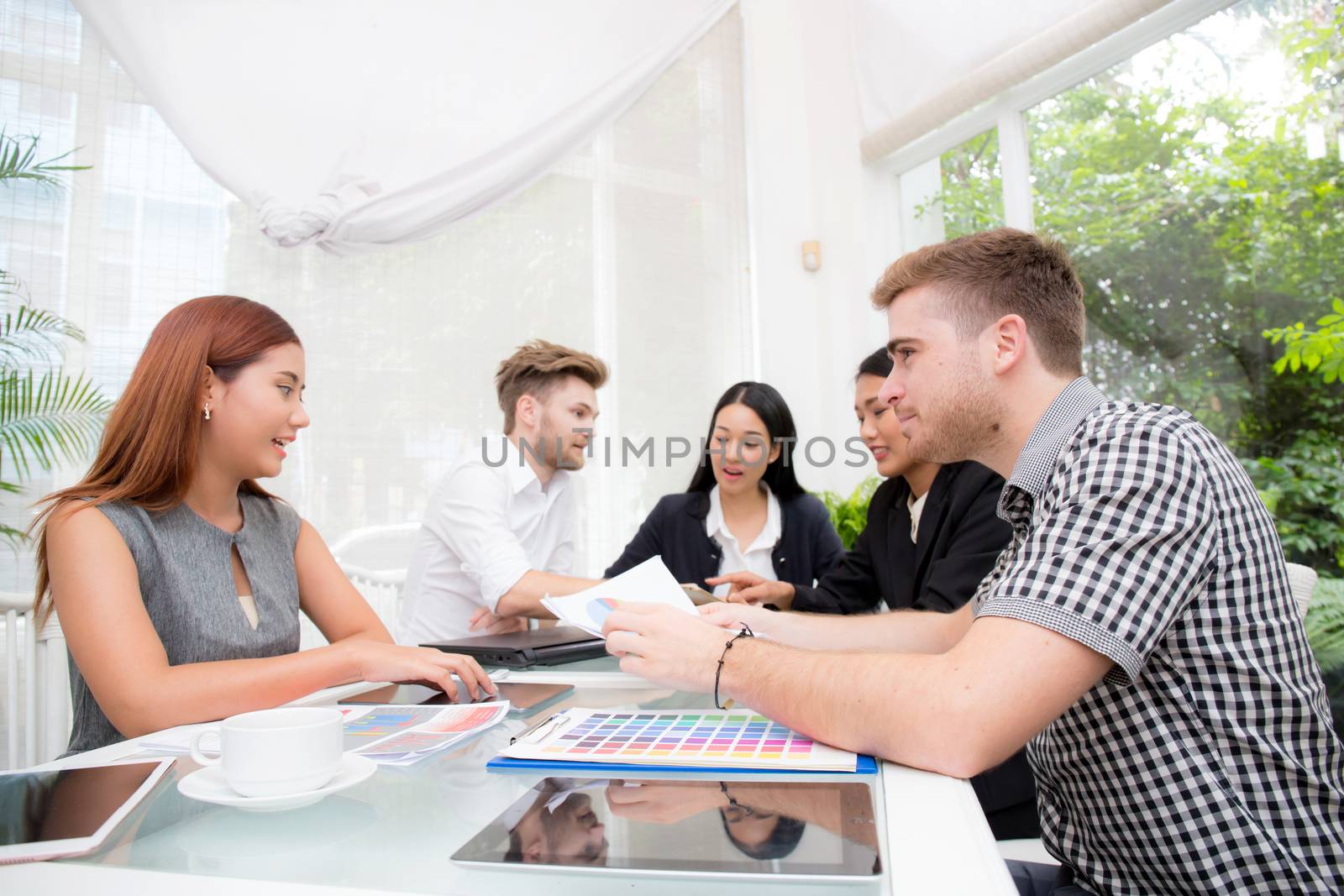 Group of business people brainstorming together in the meeting room.