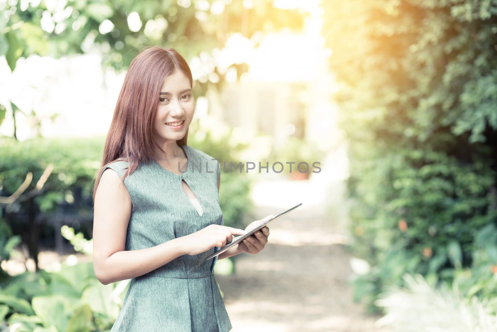 Closeup of young smart woman with tablet outdoors. Distance education.
