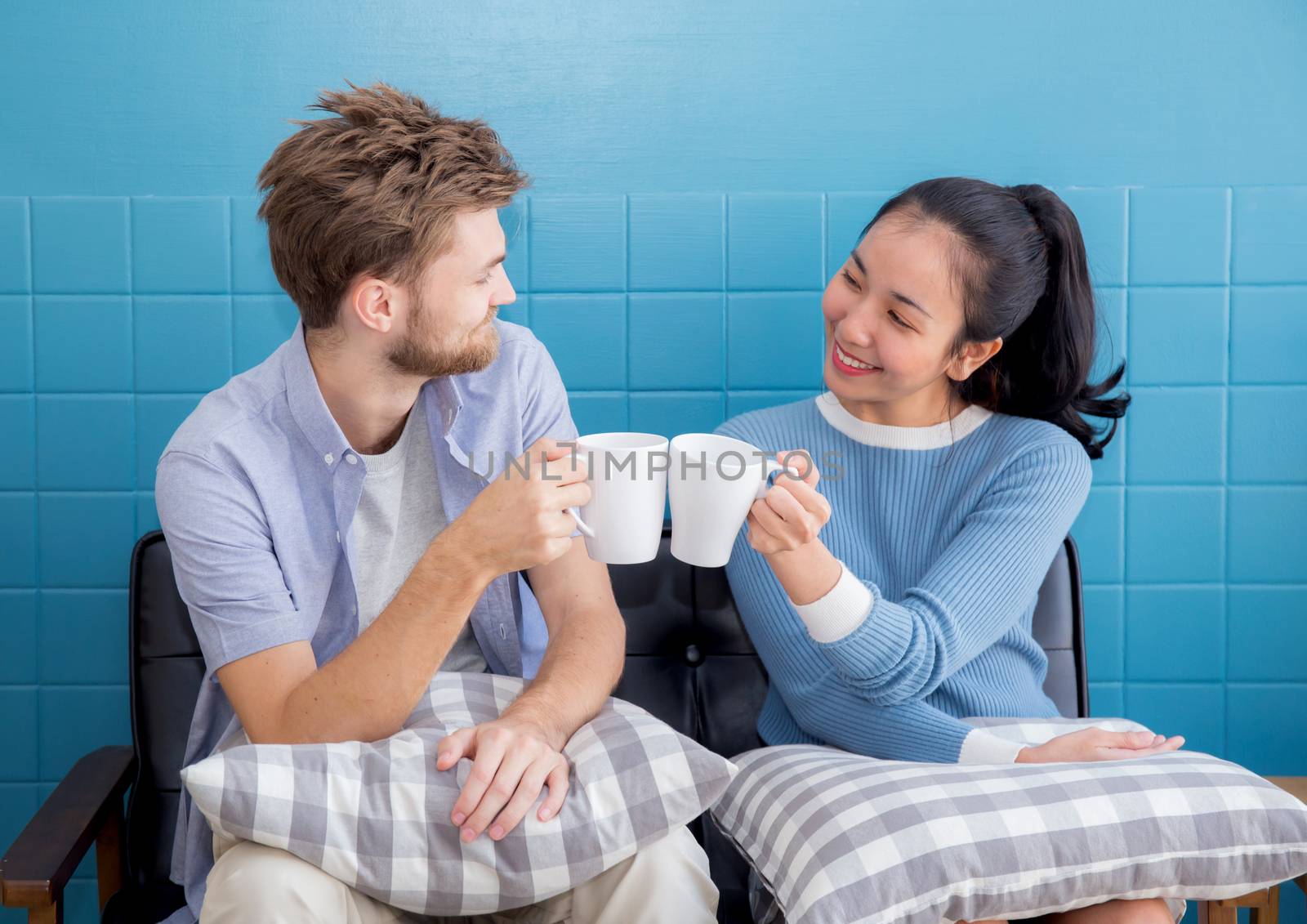 Two people couple in living room enjoy with drink coffee with success.