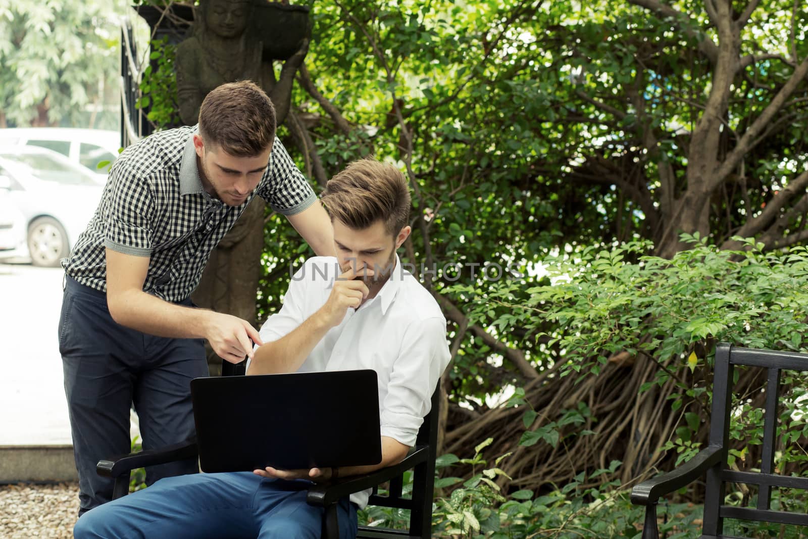 Two business people use of the notebook computer at outdoor by nnudoo