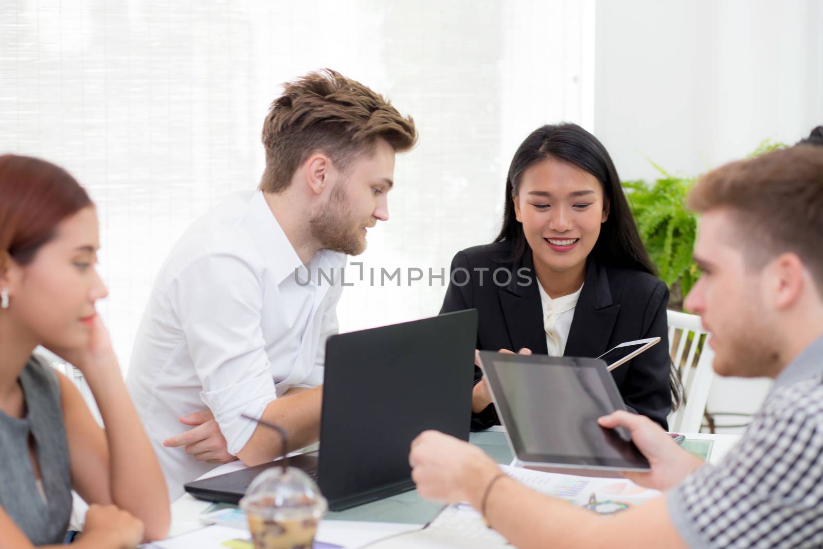 Group Business people looking at a laptop during a meeting for p by nnudoo