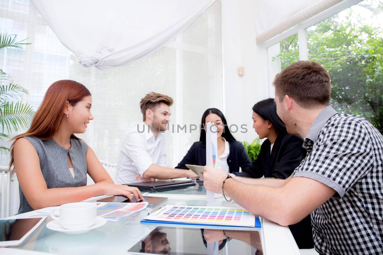 Group of business people brainstorming together in the meeting r by nnudoo