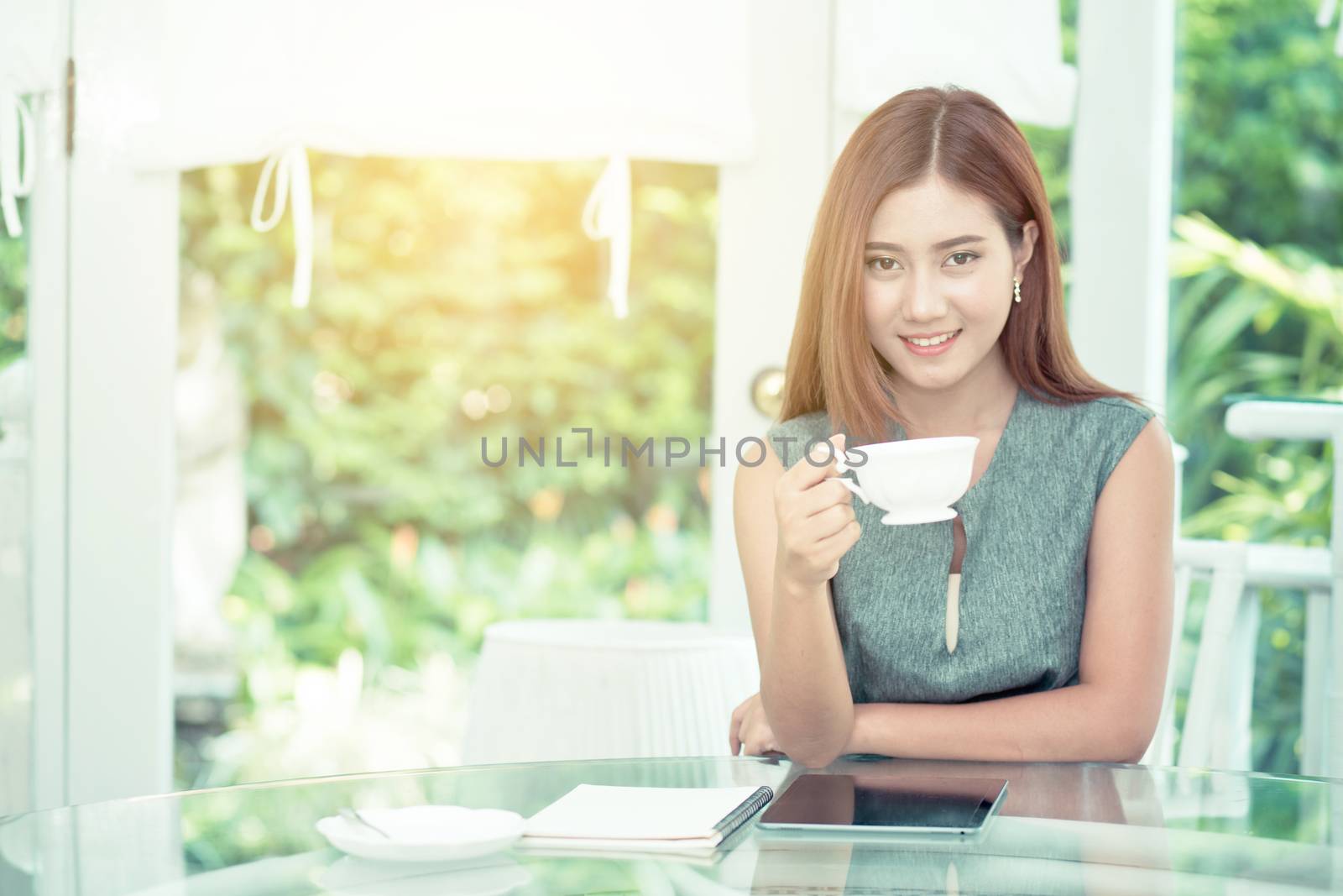 Beautiful businesswoman have enjoyed in the garden with coffee.