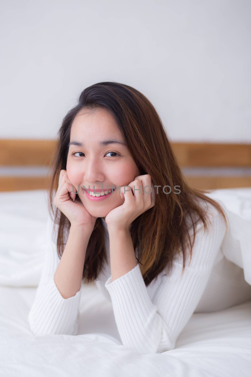 woman beautiful smiling woman portrait wake up early morning after sleeping and lying in bed.