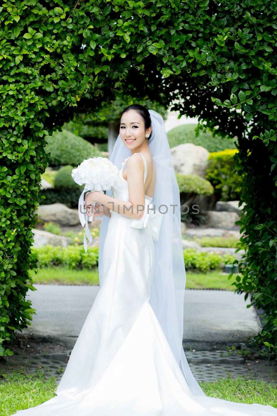 beautiful young woman on wedding day in white dress in the garden - Female portrait in the park - Selective focus.