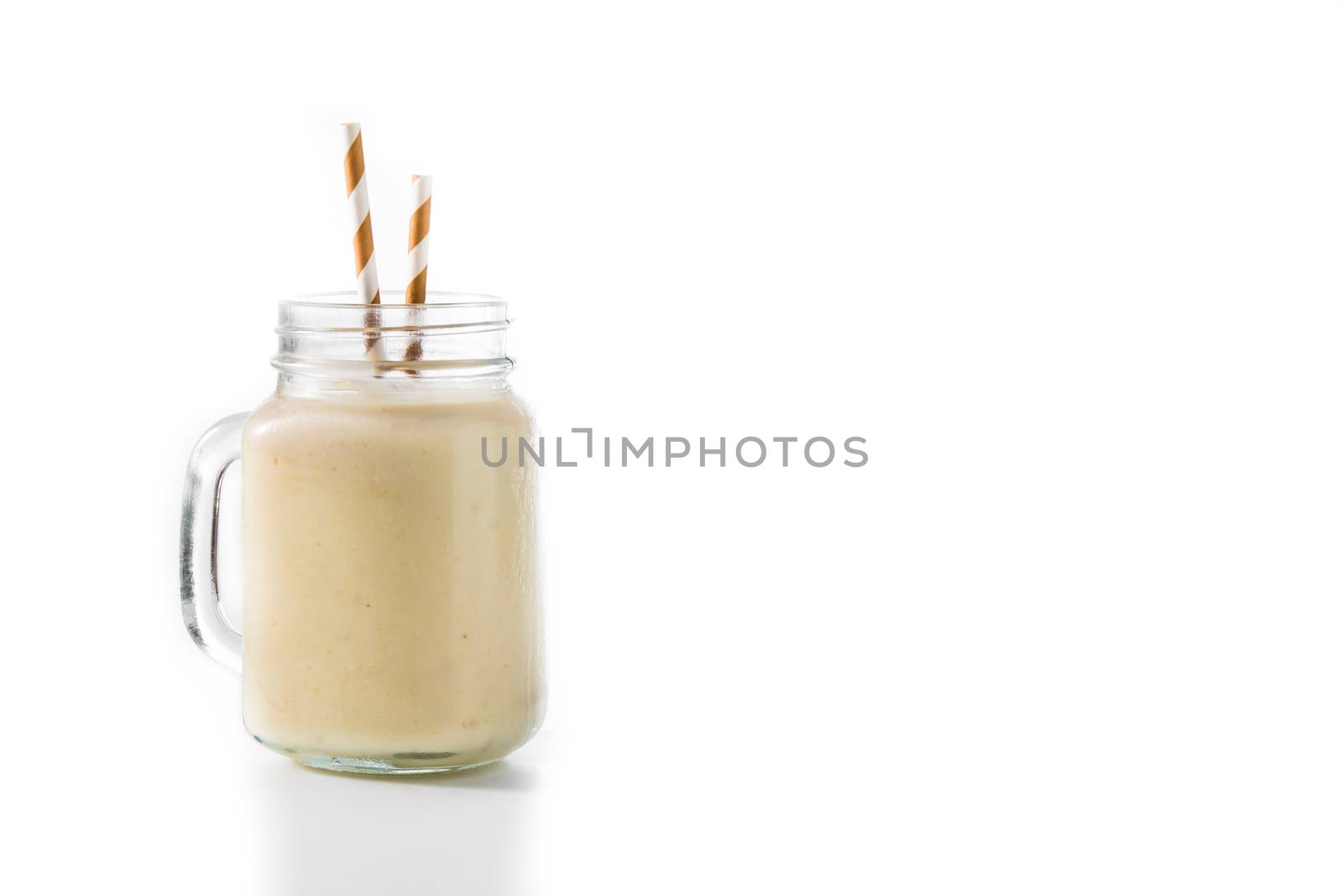 Banana smoothie with almond in jar isolated on white background