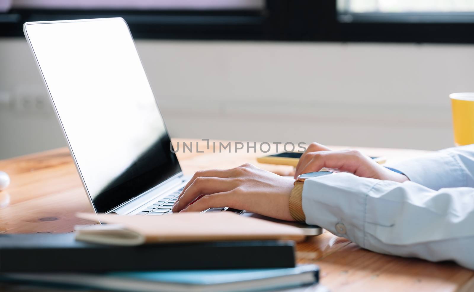 Close up of woman using laptop computer at home by nateemee