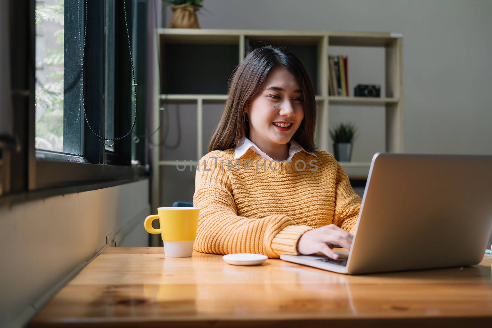 Portrait asian girl using laptop computer at home by nateemee