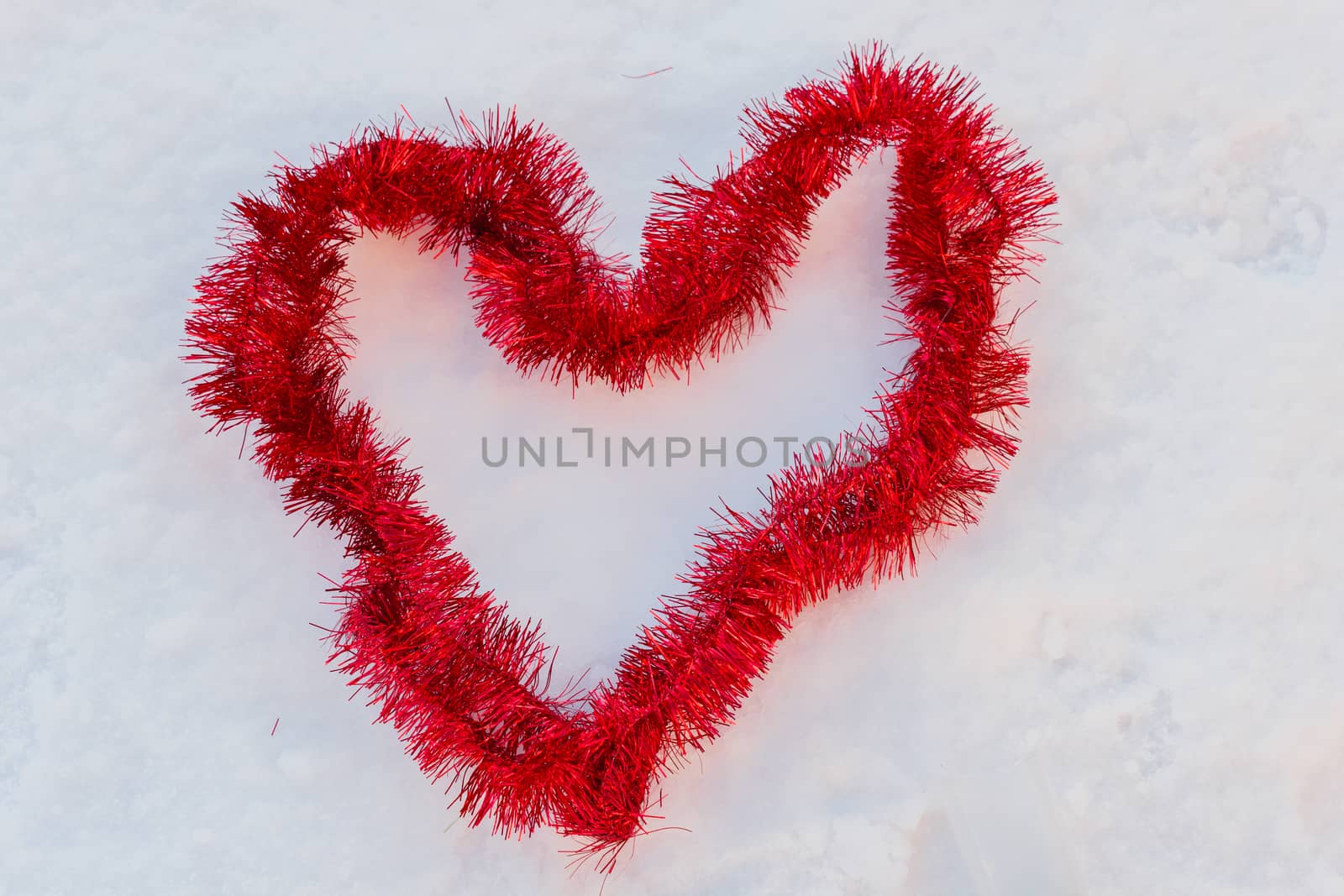 a red heart in the snow made of christmas wires by moorea