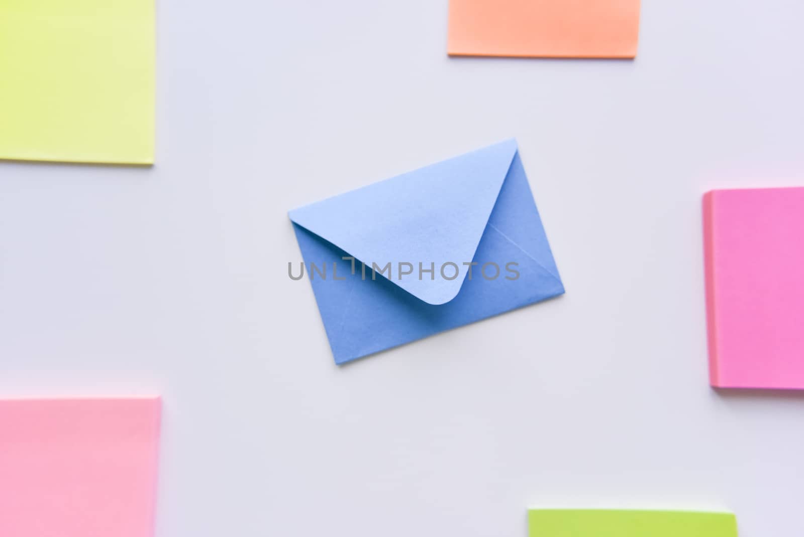 selective focus, blue envelope in the center with bright colored rectangles on sides