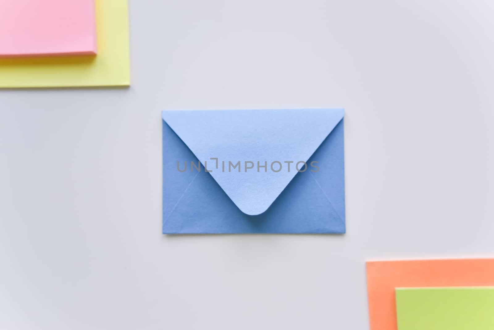 selective focus, blue envelope in the center with bright colored rectangles in corners