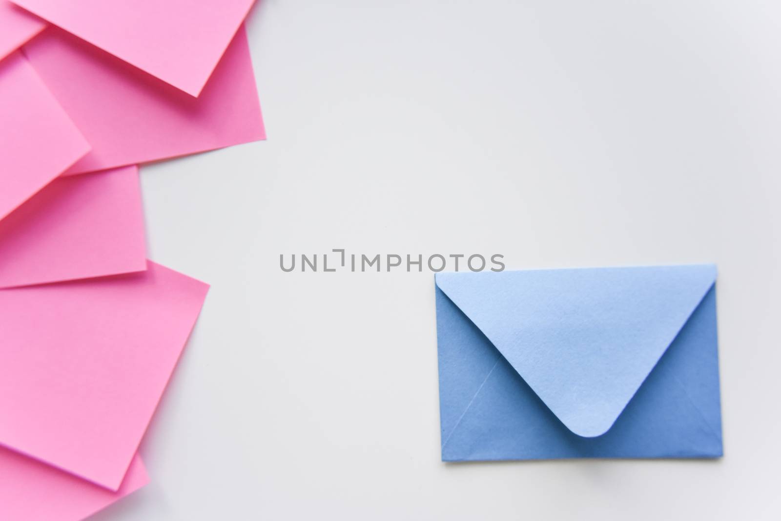 selective focus, blue envelope in the corner and pink stickers on the side