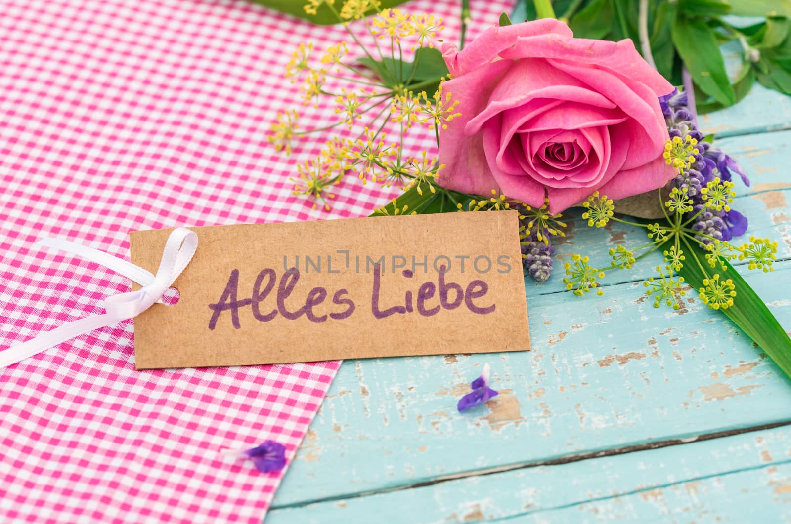 Romantic bunch of flowers and card with german text, Alles Liebe, means love