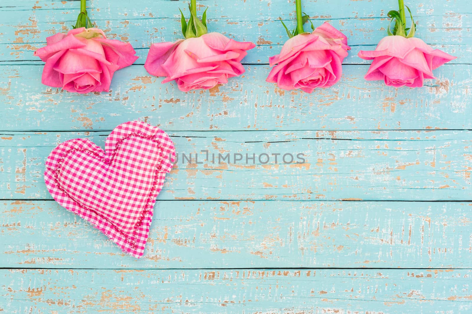 Valentines day heart with fresh pink roses on blue wooden background by Vulcano