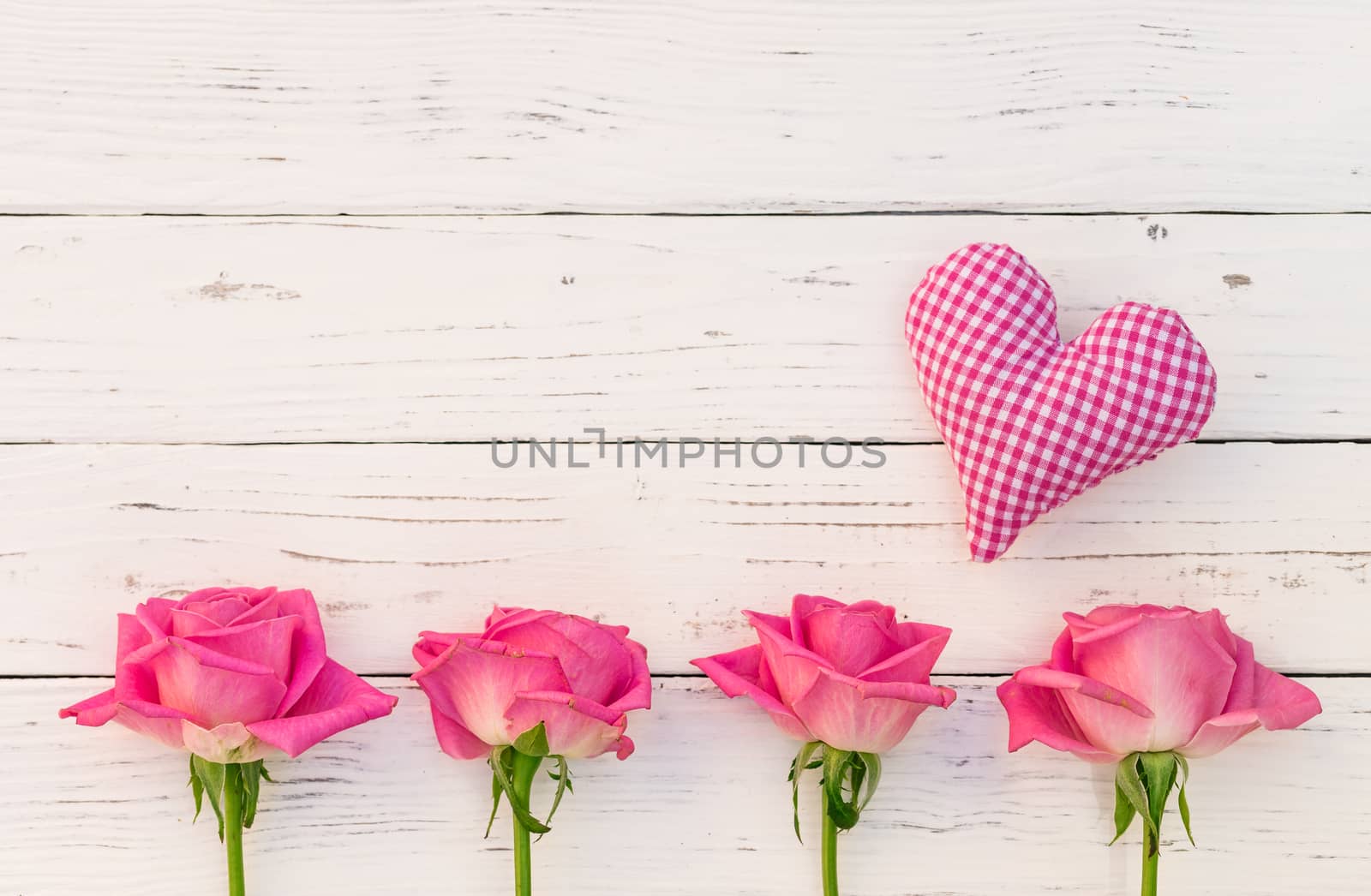 Love background with little heart and pink roses on white wood with copy space