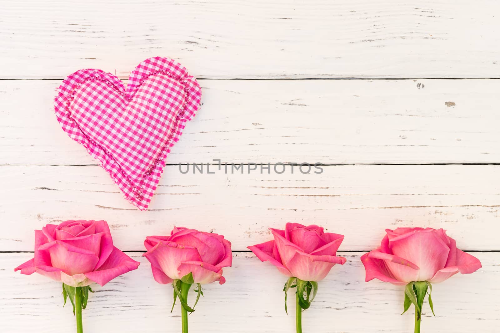 Romantic heart with pink roses on white wooden background for Mother's day