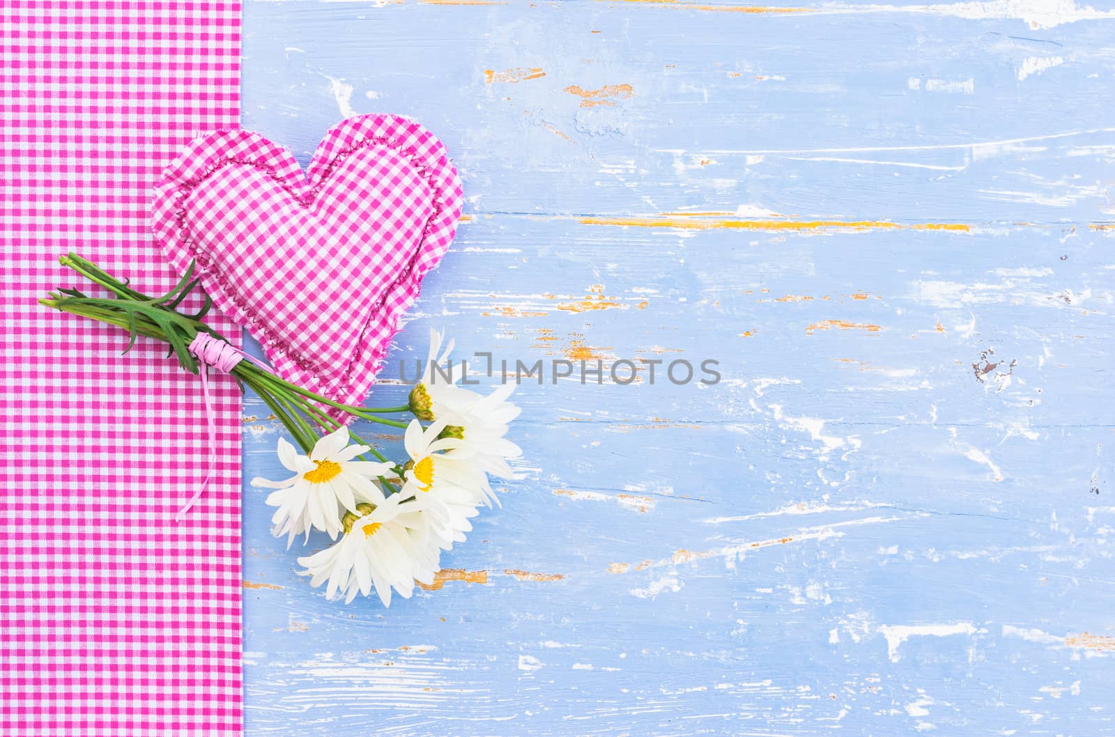 Romantic background for Mother's day with marguerite daisy flowers and pink heart