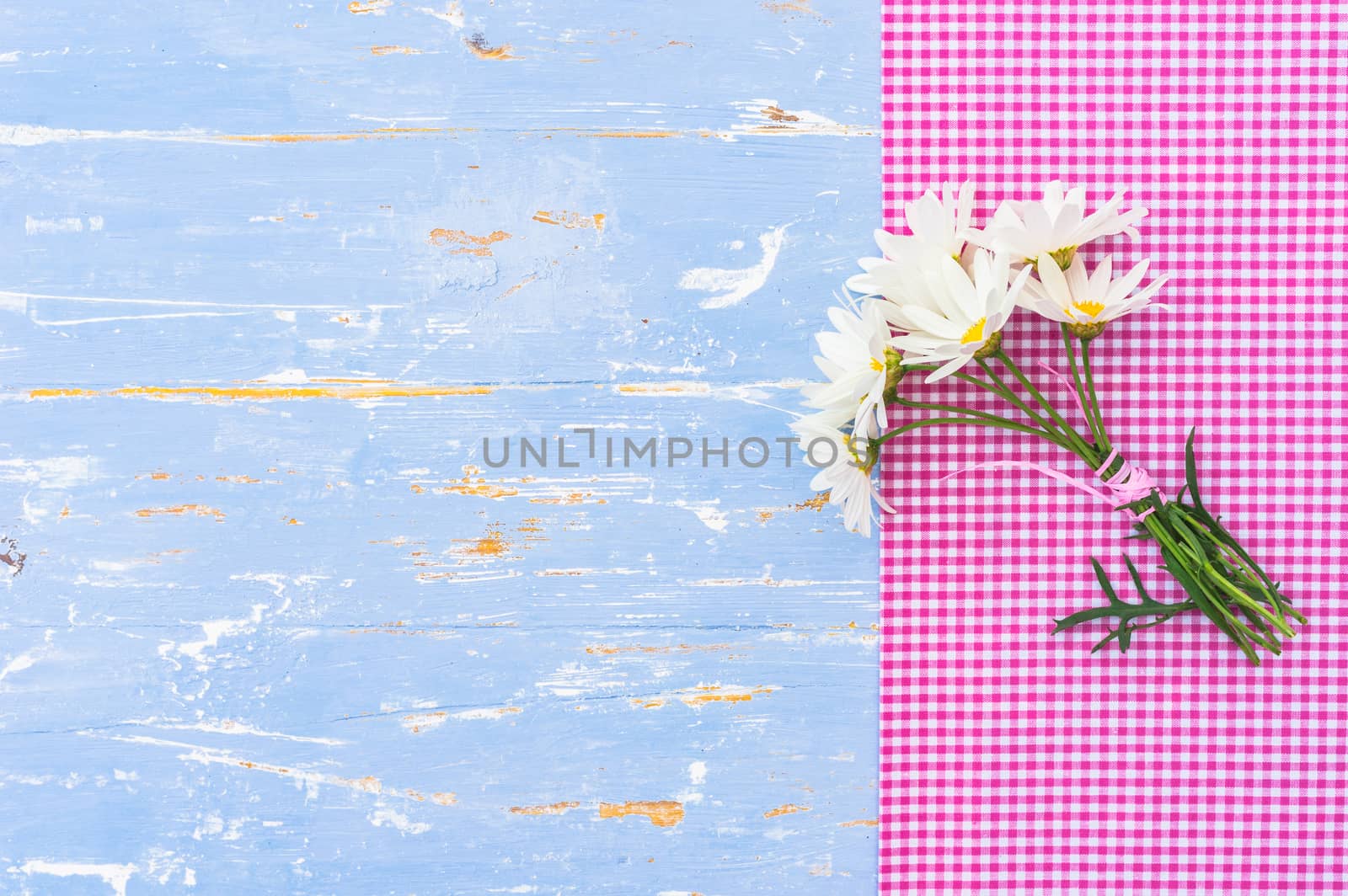 Romantic flowers background for Mothers day on blue wood with copy space