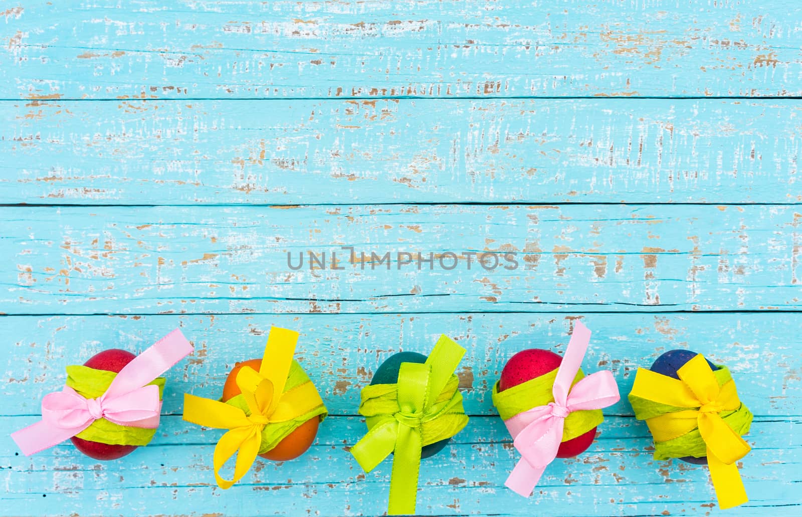 Colorful easter eggs decoration on turquoise wooden background with copy space
