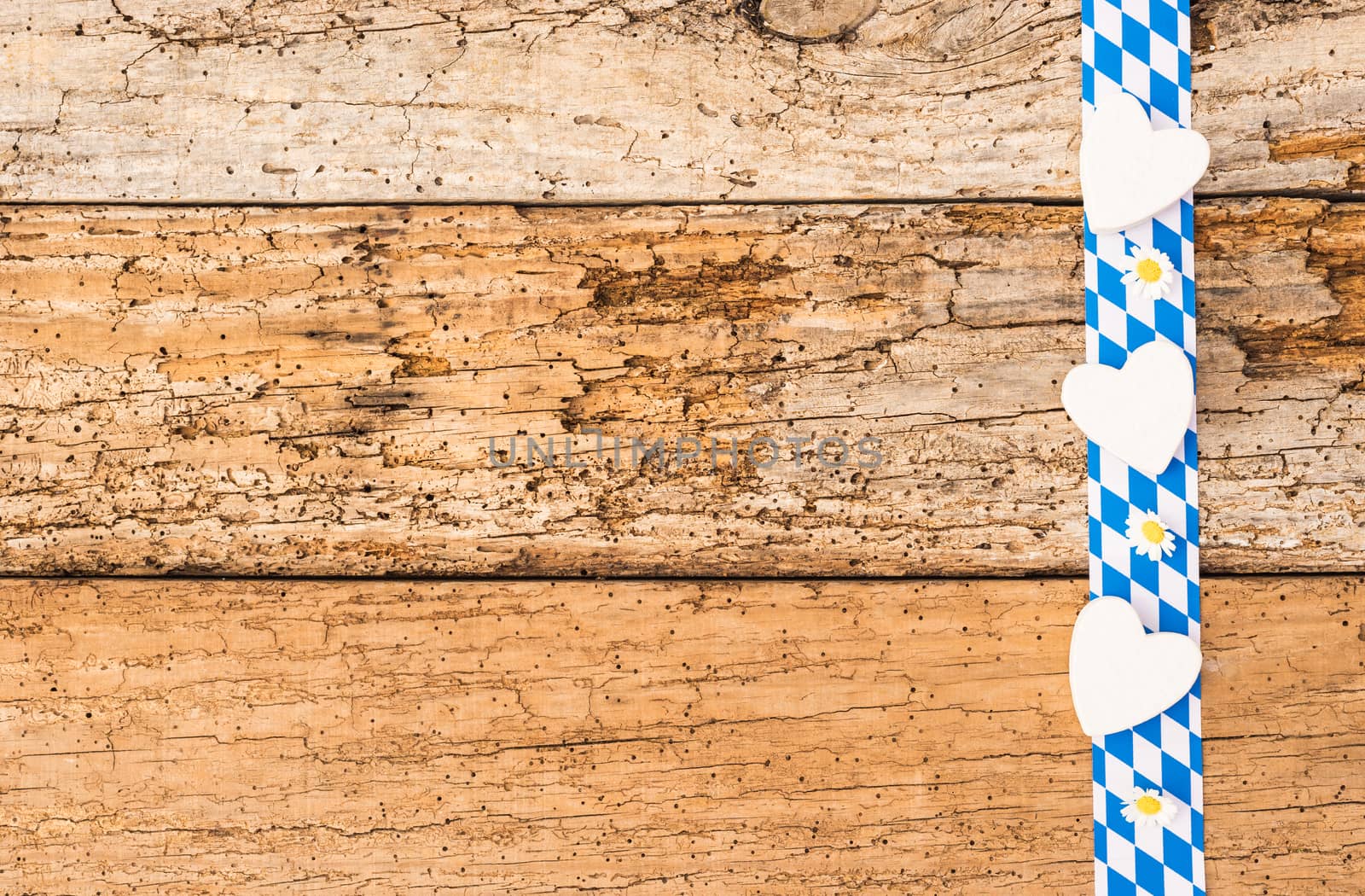 Rustic old wooden planks with bavarian border, hearts, flowers and copy space