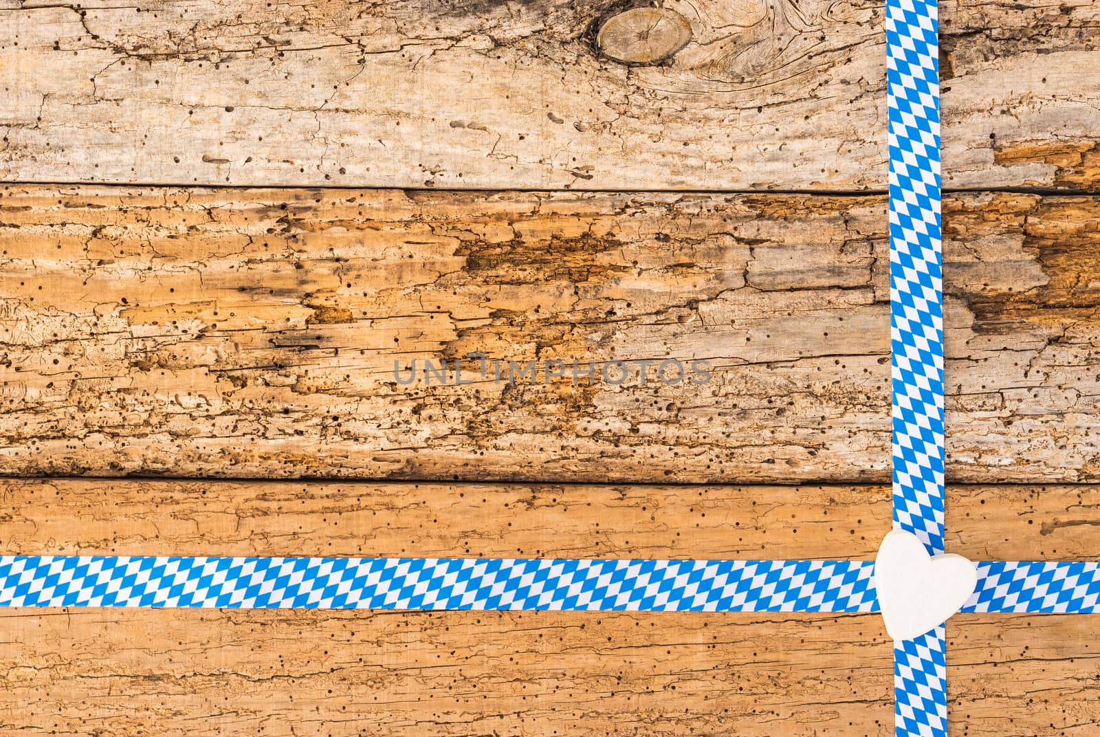 Old wooden background for Oktoberfest with traditional bavarian pattern, heart and copy space