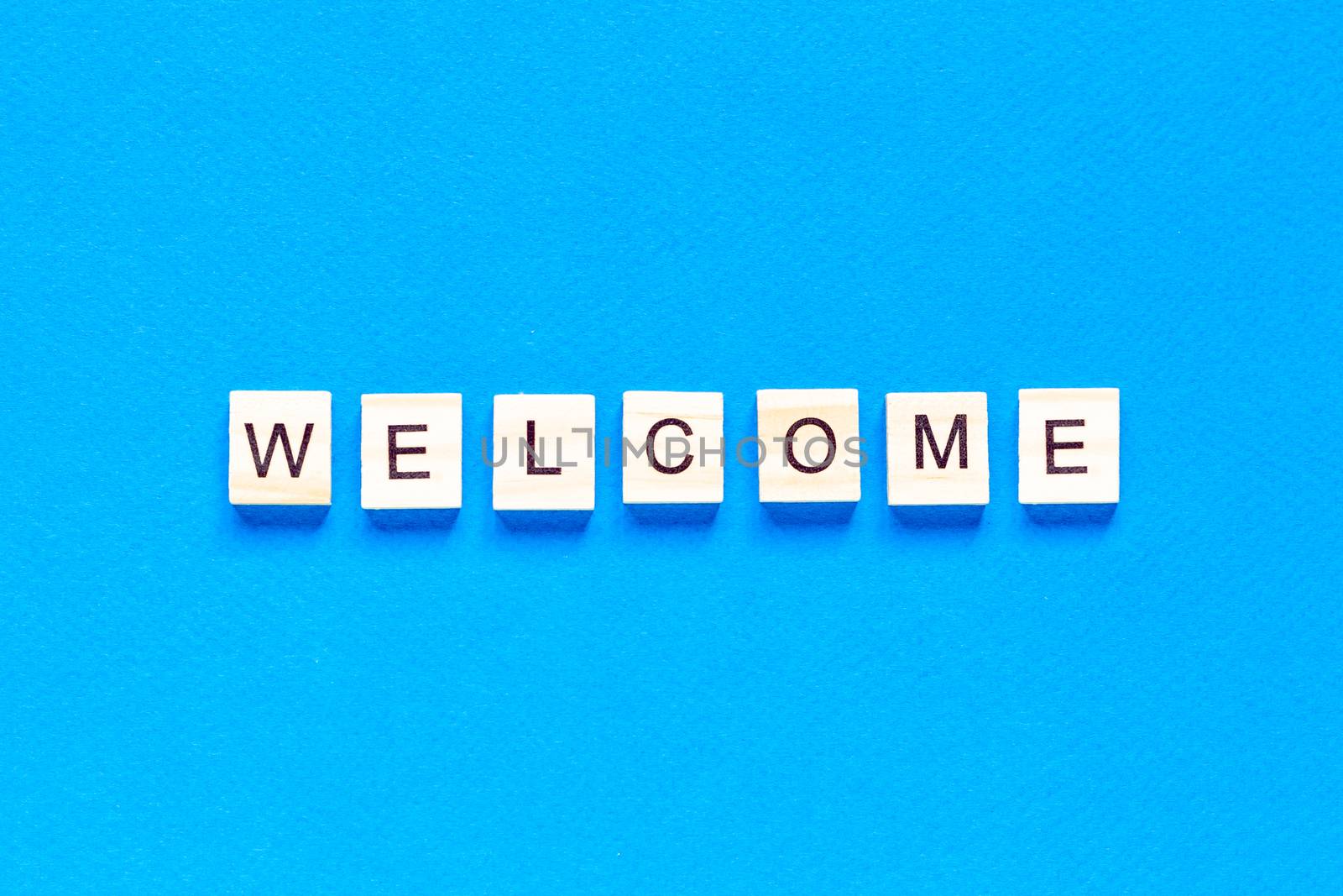 welcome sign in wooden letters on a blue background. Business concept, sales, stores, gifts. top view. The view from the top. by Pirlik