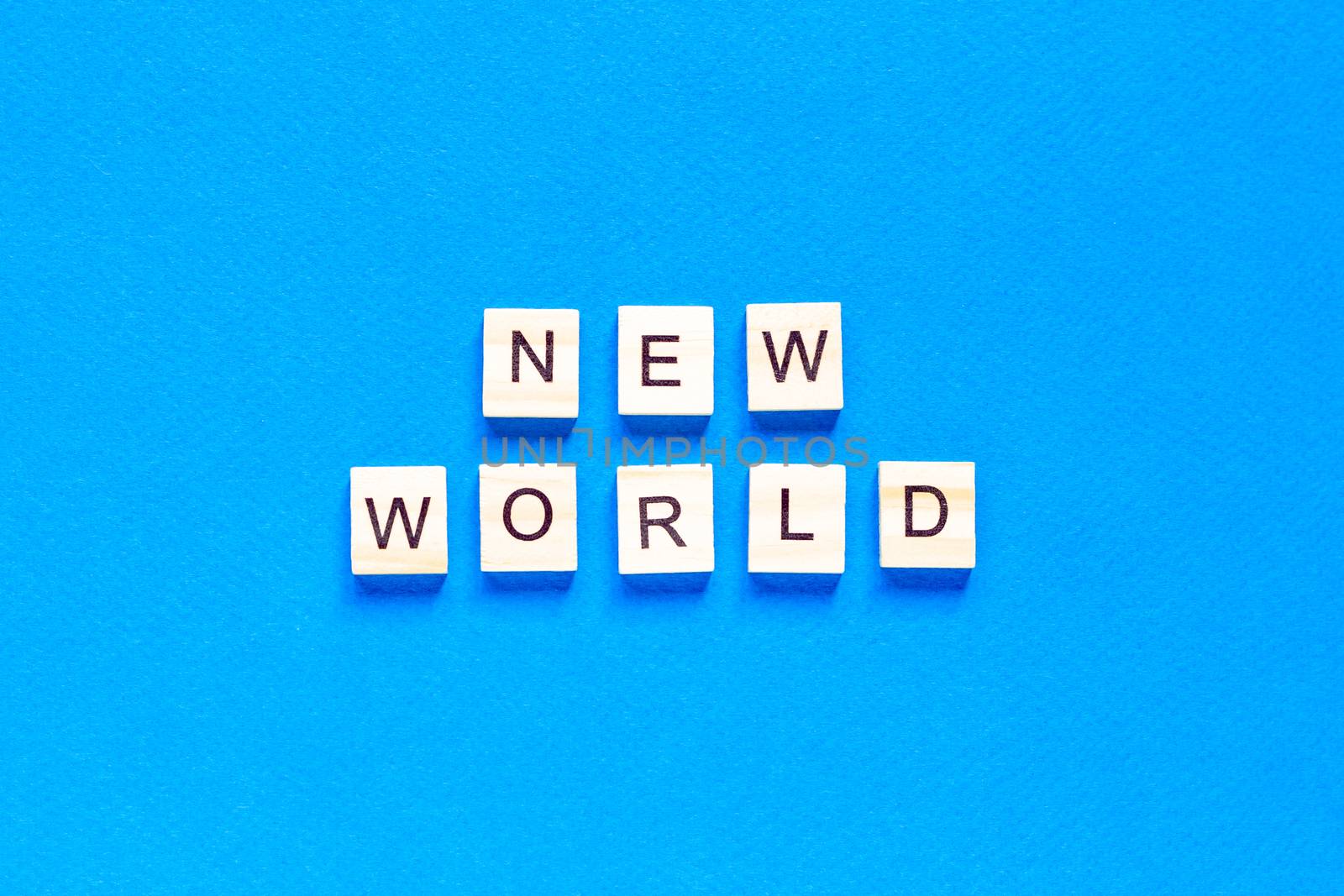 NEW WORLD word on wooden alphabet cube. New normal concept. top view, flat layout. by Pirlik