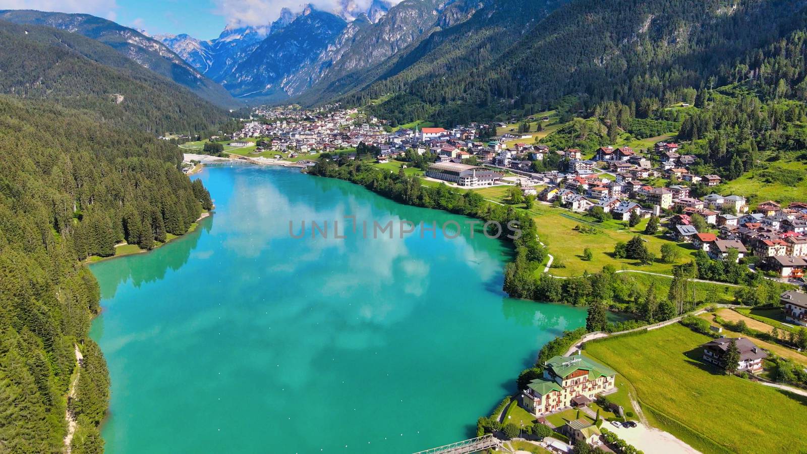 Aerial view of Auronzo Lake and Town in summertime, italian dolomites.