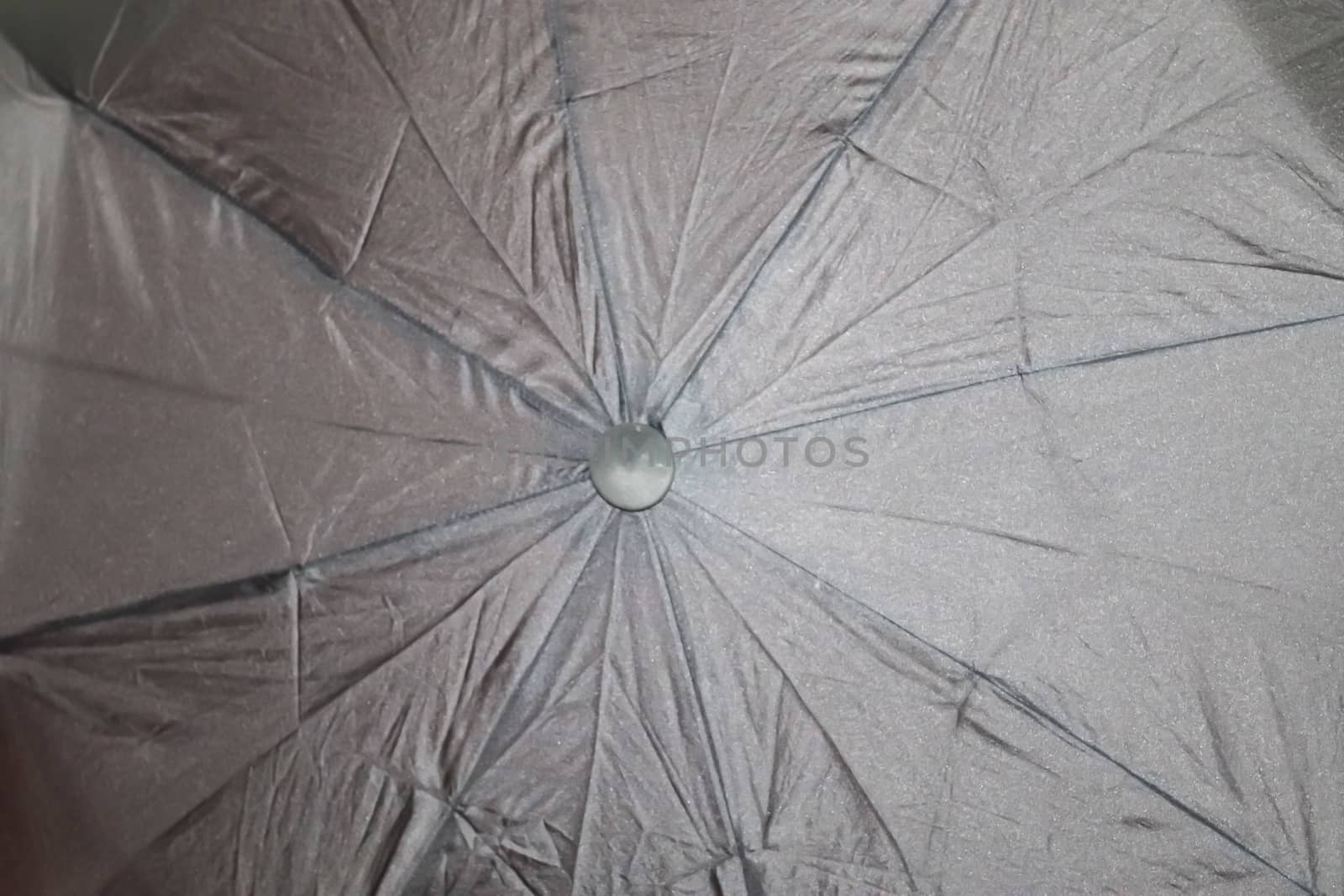 Close up view at the colorful surface of a rainproof umbrella