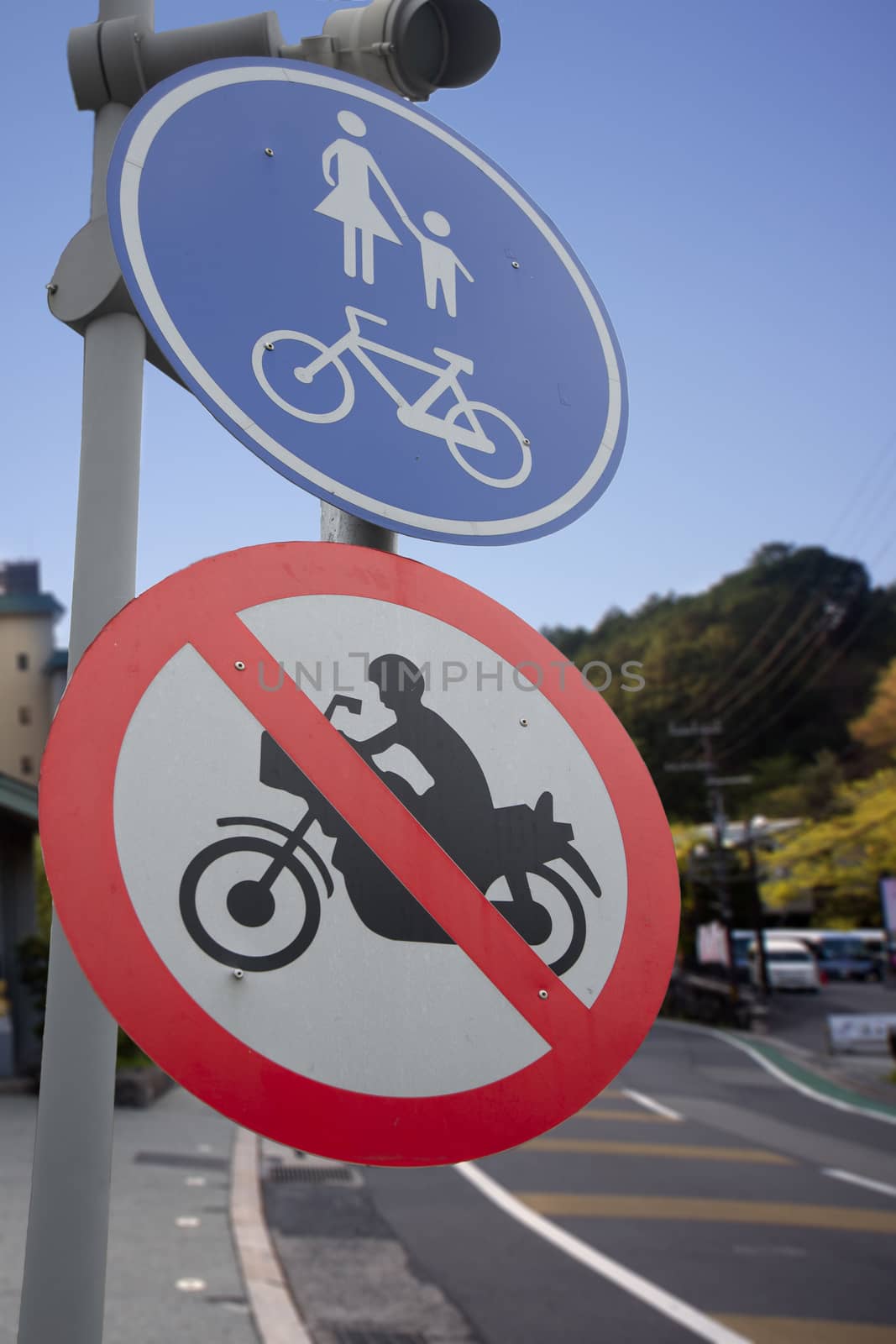 Traffic sigh show bicycle and pedestrian zone area on road.