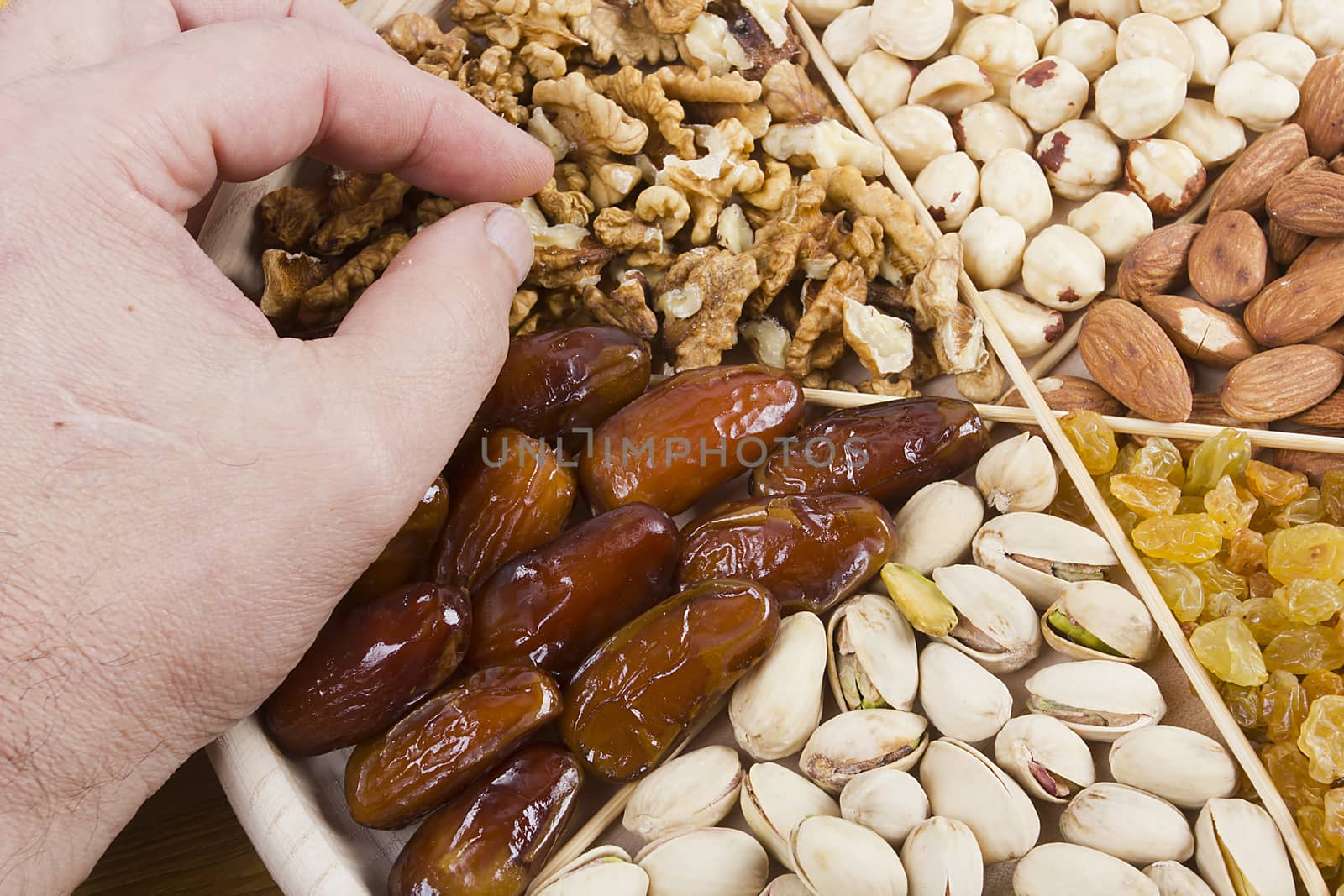 Set of nuts and dried fruits on a wooden table