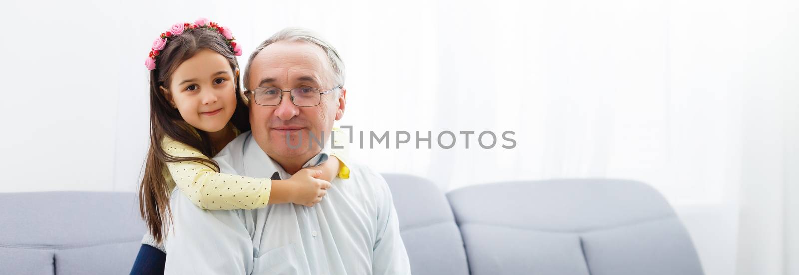 Funny lifestyle portrait of grandchild embracing grandfather by Andelov13