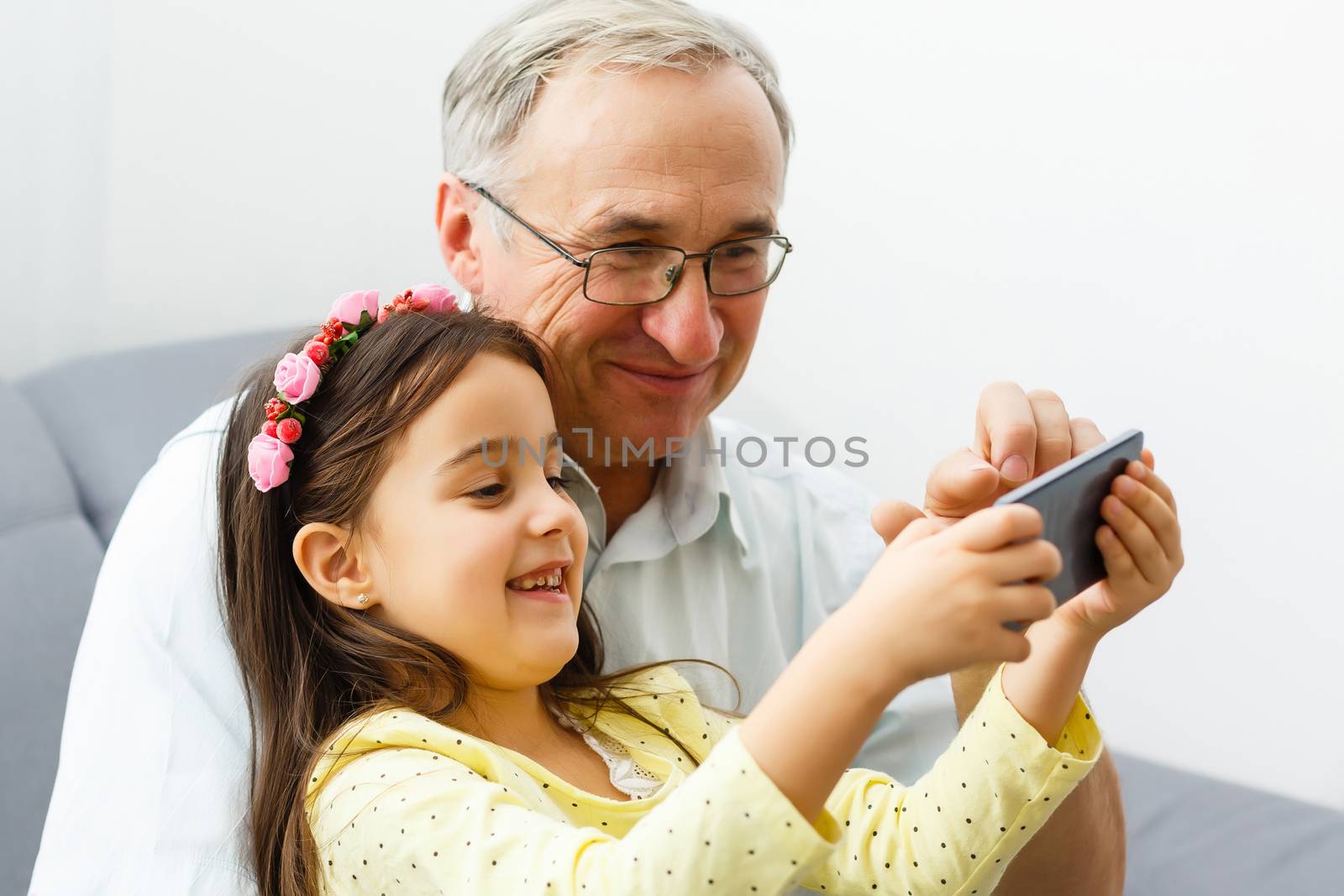 Grandfather taking a selfie with his granddaughter by Andelov13
