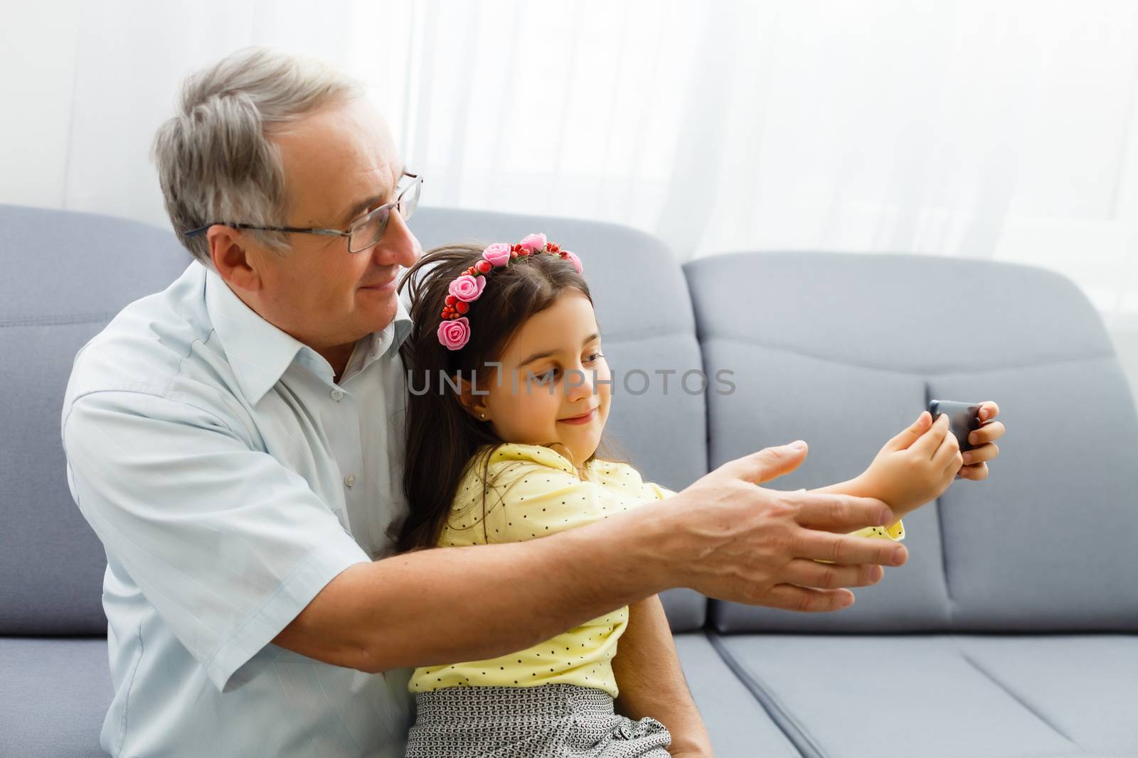 Grandfather and granddaughter make selfie