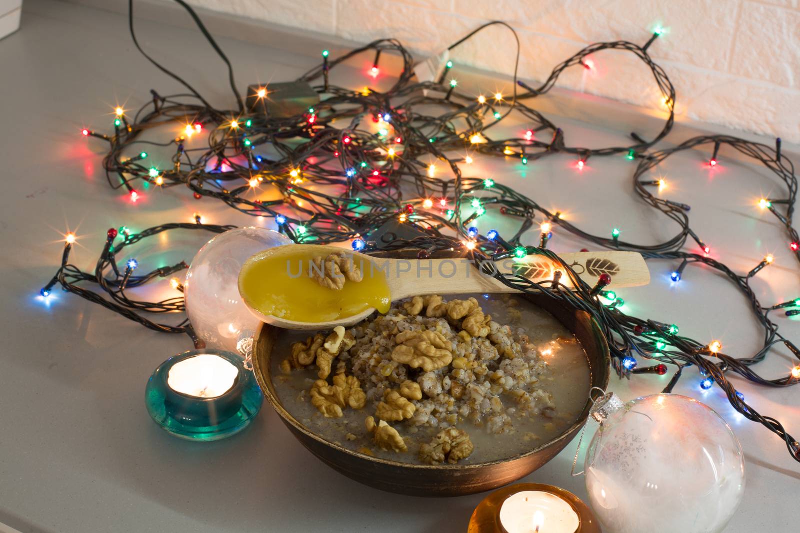 Bowl with kutia - traditional Christmas sweet meal in Ukraine, Belarus and Poland, on wooden table, on bright background